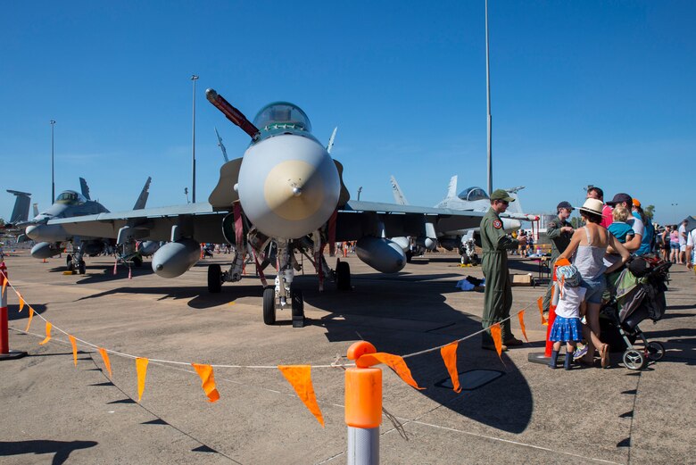 Visitors observe a Royal Australian Air Force 77 Squadron F/A-18 Hornet during Exercise Pitch Black 2016 Open Day at Royal Australian Air Force Base Darwin, Australia, Aug. 13, 2016. This event showcased military aircraft participating in Pitch Black, provided tours, and shared knowledge and experiences to the local community, helping them gain a new perspective on the international and regional importance of Pitch Black.  The biennial, multinational exercise involves approximately 10 allied nations and prepares these forces for possible real-world scenarios. The bilateral effort amongst Exercise Pitch Black 2016 furthermore showcases the strength amongst various militaries and solidifies the relationship across the Pacific region. (U.S. Marine Corps photo by Cpl. Nicole Zurbrugg)