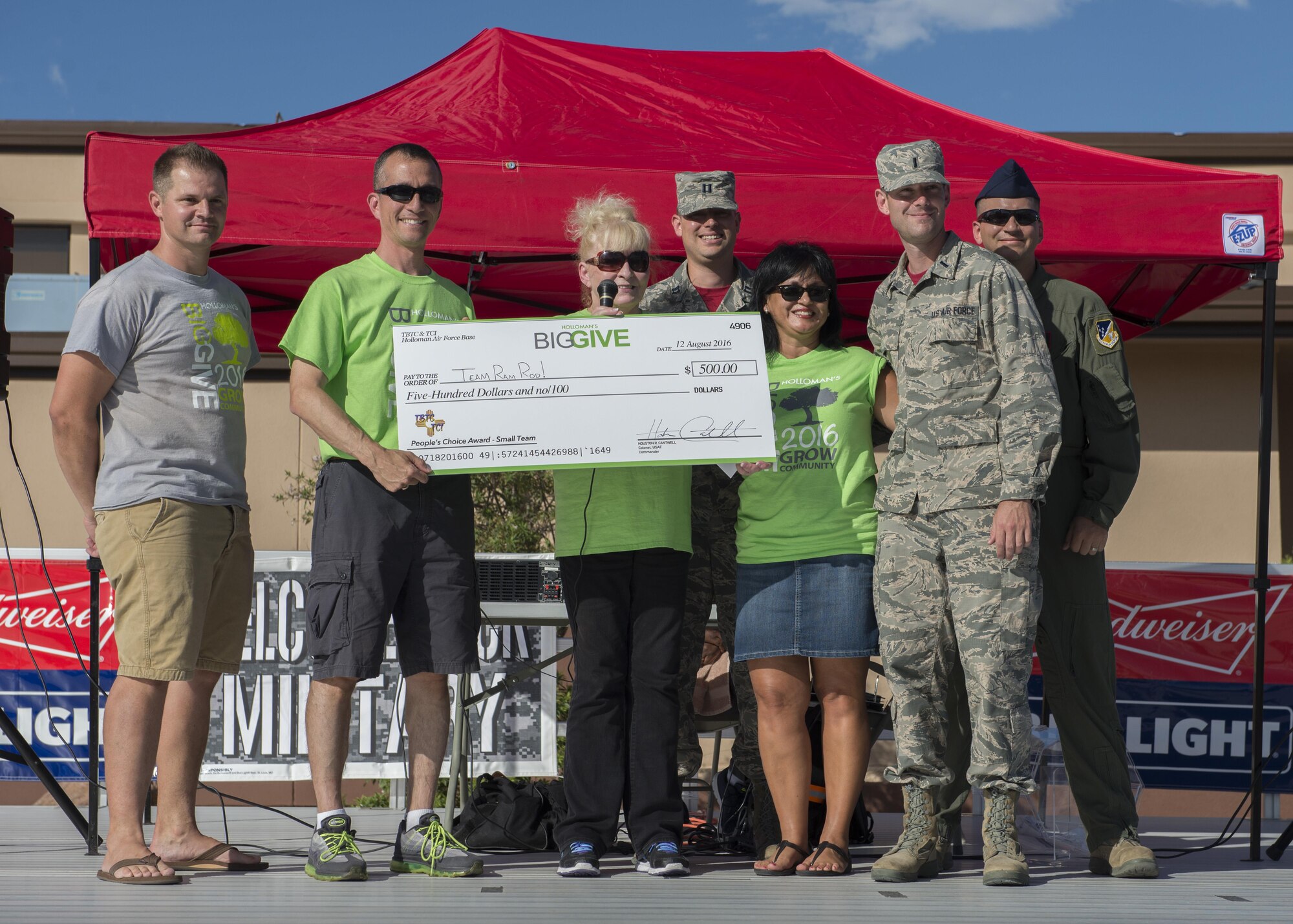 Members from the 49th Operation Support Squadron’s Team Ram Rod! receive their $500 reward for winning the People’s Choice Small Team Award during the Big Give after-party August 12, 2016 at Holloman Air Force Base, N.M. Over the course of three weeks, 32 teams of 412 participants spent nearly 5,000 man hours volunteering in the local community — saving the area $202,092.33. (Last names are being withheld due to operational requirements. U.S. Air Force photo by Airman 1st Class Randahl J. Jenson)