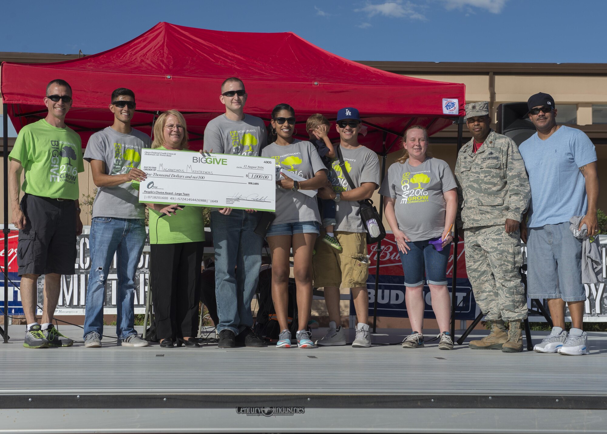 Members from the 49th Maintenance Squadron’s Magnanimous Maintainers receive their $1,000 reward for winning the People’s Choice Large Team Award at the Big Give after-party August 12, 2016 at Holloman Air Force Base, N.M. Over the course of three weeks, 32 teams of 412 participants spent nearly 5,000 man hours volunteering in the local community — saving the area $202,092.33. (Last names are being withheld due to operational requirements. U.S. Air Force photo by Airman 1st Class Randahl J. Jenson)