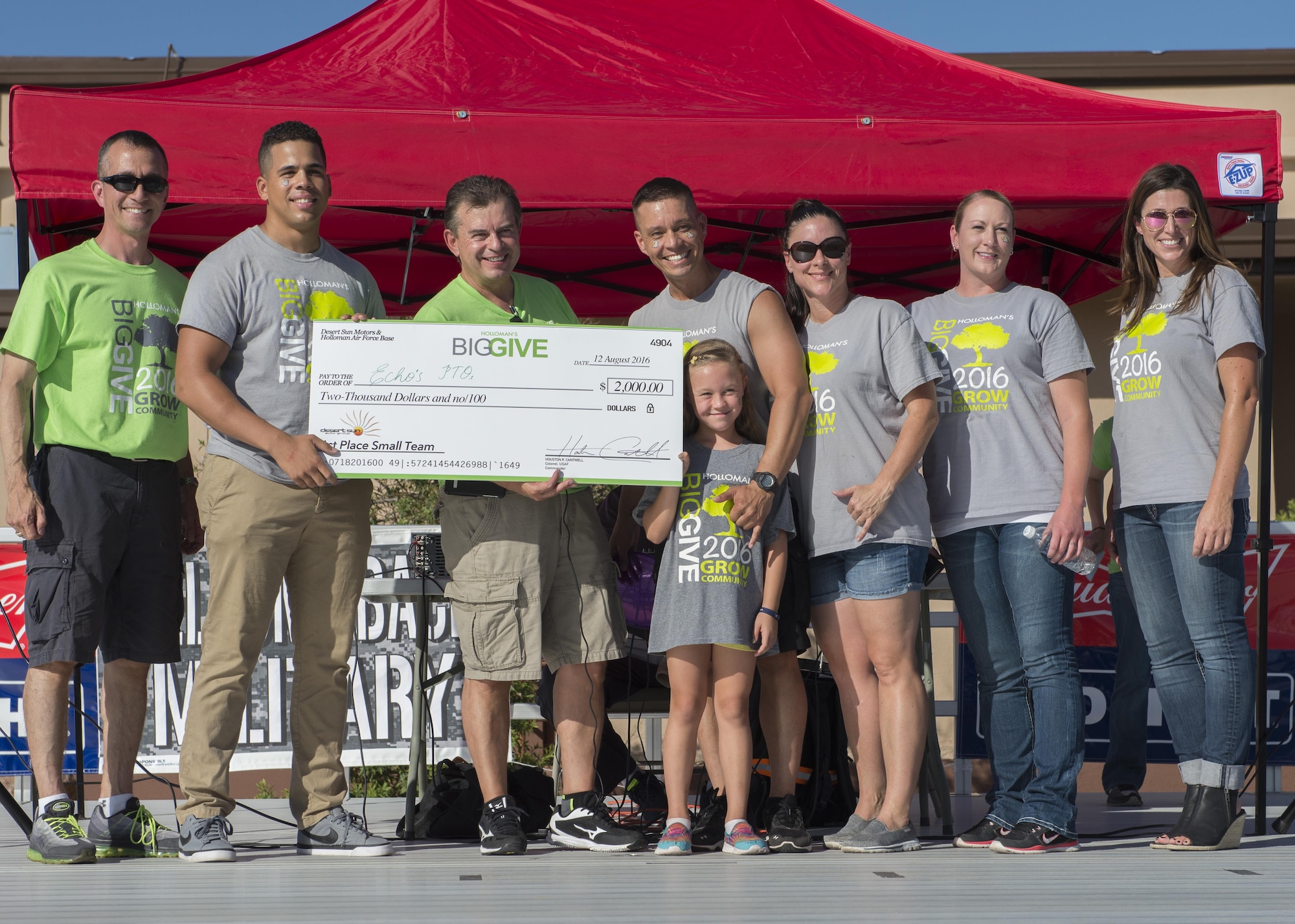 Members from the 49th Mission Support Group’s Echo’s PTO receive their $2,000 reward for winning the Small Team Award at the Big Give after-party August 12, 2016 at Holloman Air Force Base, N.M. Over the course of three weeks, 32 teams of 412 participants spent nearly 5,000 man hours volunteering in the local community — saving the area $202,092.33. (U.S. Air Force photo by Airman 1st Class Randahl J. Jenson)