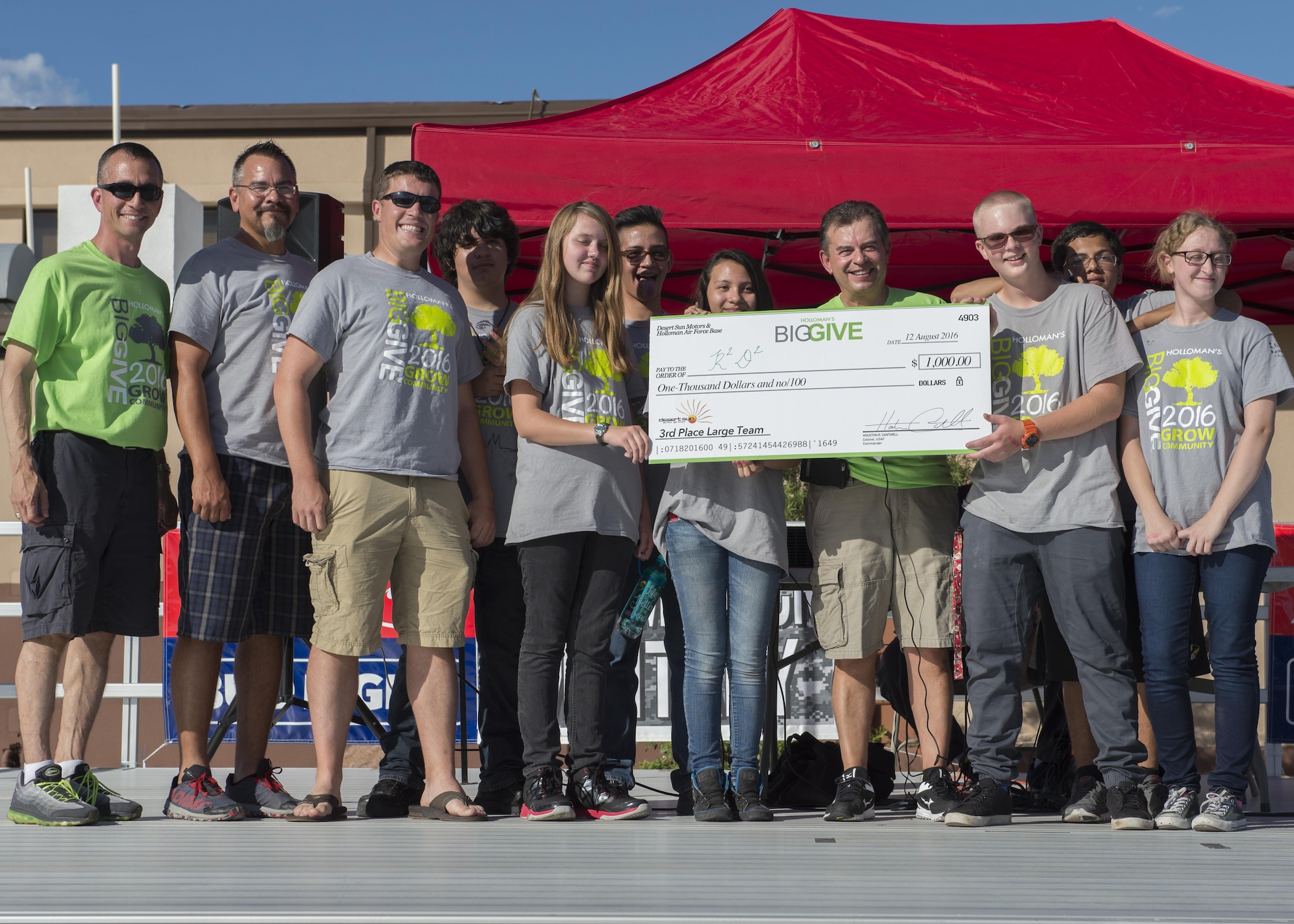 Members from the 6th Attack Squadron’s R2D2 receive their $1,000 reward for winning the Third Place Large Team Award at the Big Give after-party August 12, 2016 at Holloman Air Force Base, N.M. Over the course of three weeks, 32 teams of 412 participants spent nearly 5,000 man hours volunteering in the local community — saving the area $202,092.33. (U.S. Air Force photo by Airman 1st Class Randahl J. Jenson)