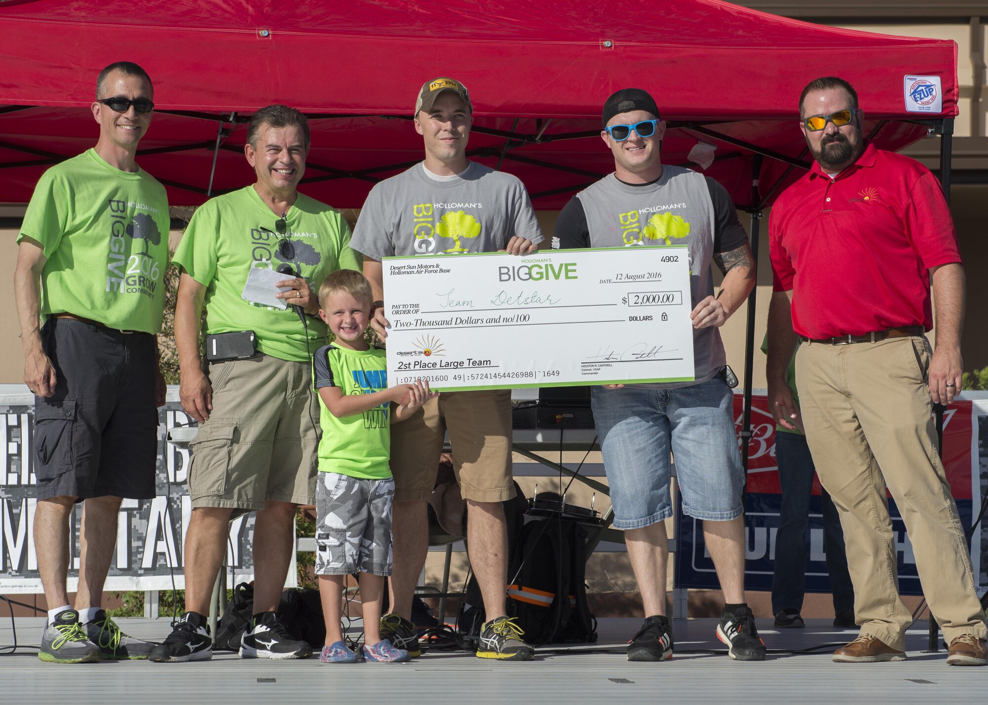 Members from the 372nd Training Squadron Detachment 10’s Team Detstar receive their $2,000 reward for winning the Second Place Large Team Award at the Big Give after-party August 12, 2016 at Holloman Air Force Base, N.M. Over the course of three weeks, 32 teams of 412 participants spent nearly 5,000 man hours volunteering in the local community — saving the area $202,092.33. (U.S. Air Force photo by Airman 1st Class Randahl J. Jenson)