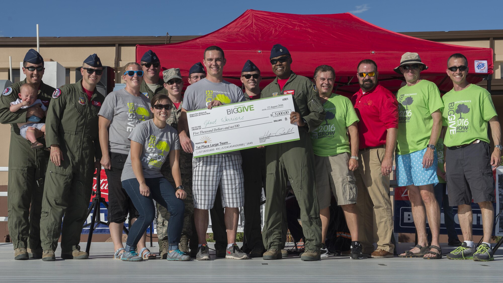 Members from the 29th Attack Squadron’s team, Ghost Warriors, receive their $5,000 reward for winning the First Place Large Team Award at the Big Give after-party August 12, 2016 at Holloman Air Force Base, N.M. Over the course of three weeks, 32 teams of 412 participants spent nearly 5,000 man hours volunteering in the local community — saving the area $202,092.33. (Last names are being withheld due to operational requirements. U.S. Air Force photo by Airman 1st Class Randahl J. Jenson)