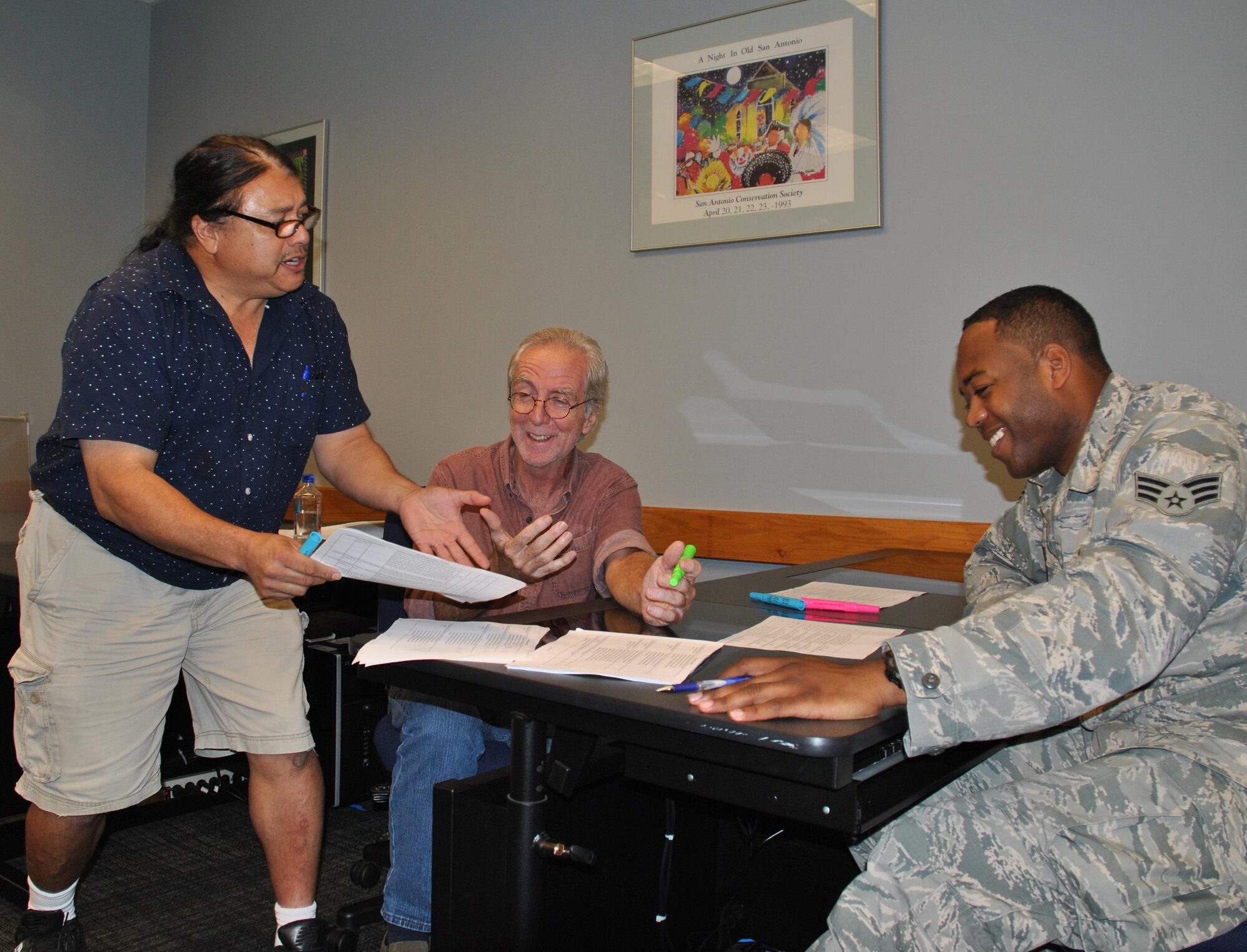 Judges for the 2016 Air Force photo contest, organized by Air Force Services Activity, discuss their score sheets. The judges are photojournalist Billy Calzada of the San Antonio Express-News, commercial photographer Gary Hartman and combat photographer Senior Airman Colville McFee with the 3rd Combat Camera Squadron, Joint Base San Antonio-Lackland. (U.S. Air Force photo/Carole Chiles Fuller)
