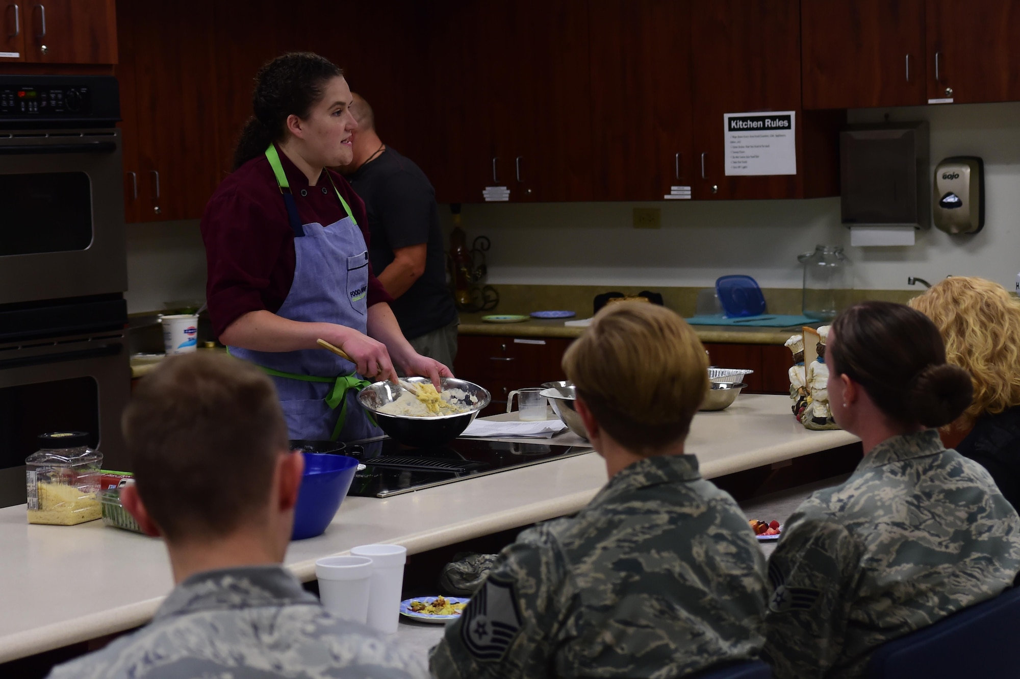 Charlotte Muller, Whole Foods chef, demonstrates to an audience how to prepare a blueberry crumble cake August 18, 2016, at the Health and Wellness Center on Buckley Air Force Base, Colo. Members of Team Buckley were invited to enjoy a meal while also learning how to prepare it during the 460th Medical Group’s monthly cooking demonstration. (U.S. Air Force photo by Senior Airman Luke W. Nowakowski/Released)