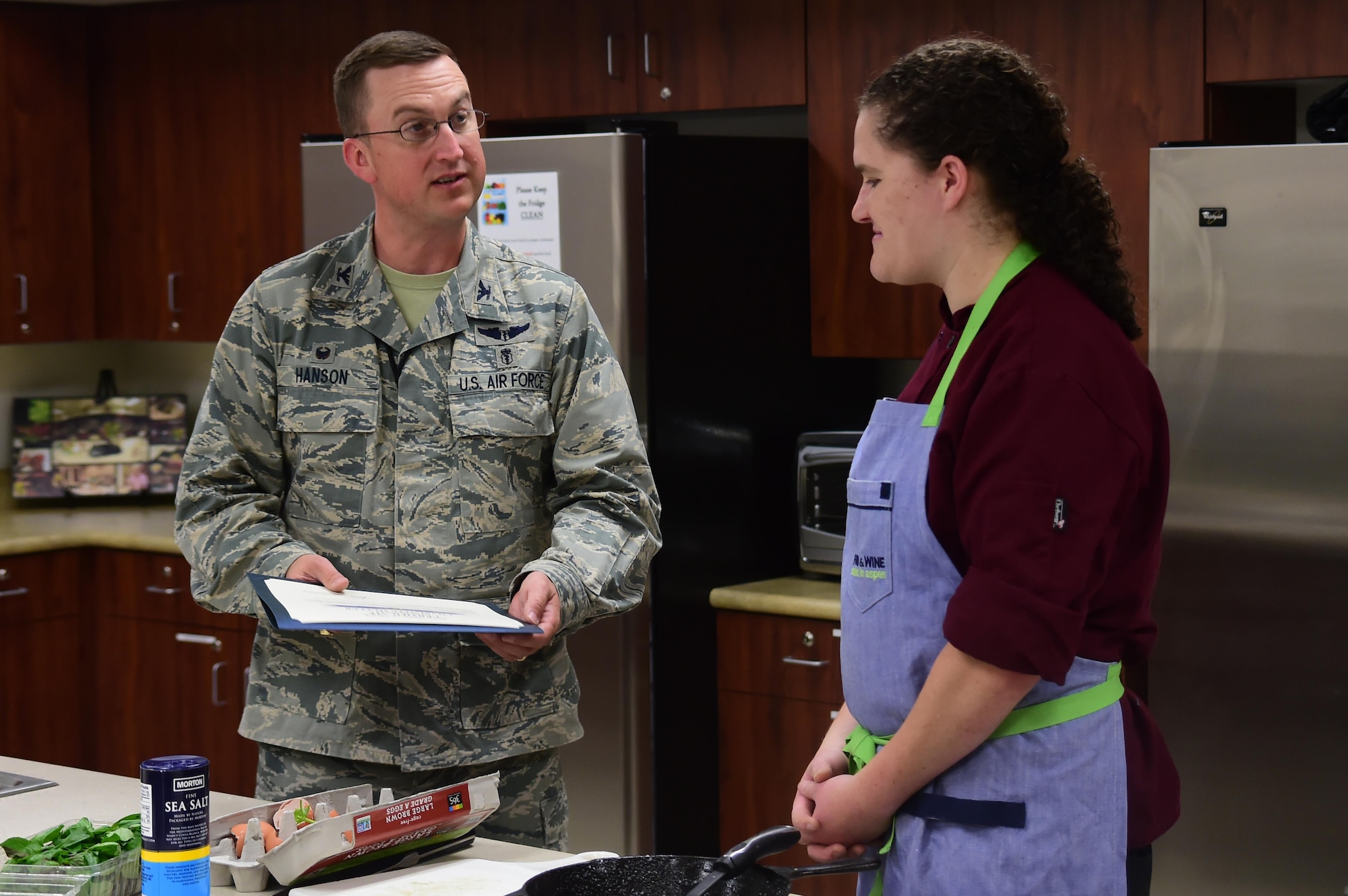 Col. Matthew Hanson, 460th Medical Group commander, presents Charlotte Muller, Whole Foods chef, a certificate of appreciation August 18, 2016, at the Health and Wellness Center on Buckley Air Force Base, Colo. Muller visits Buckley every month to put on a cooking demonstration for people looking to improve the quality and health of their own cooking. (U.S. Air Force photo by Senior Airman Luke W. Nowakowski/Released)  