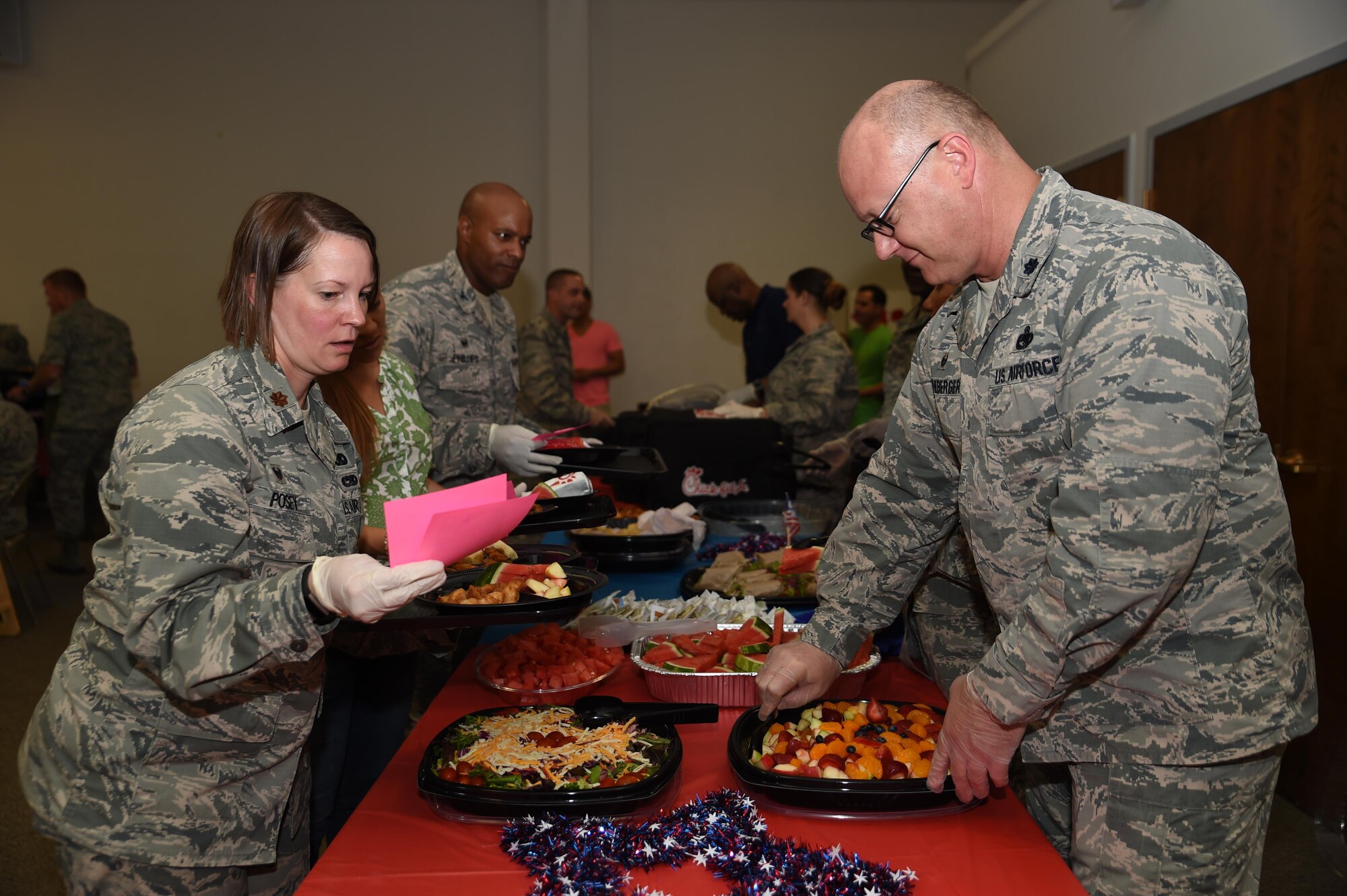 Team McChord Leadership fills menu orders at the Deployed Family Dinner August 15, 2016, at the Chapel Support Center, Joint Base Lewis-McChord, Wash. The dinner offered families of deployed members a chance to fellowship, win prizes and unwind. (U.S. Air Force photo/Staff Sgt. Naomi Shipley)