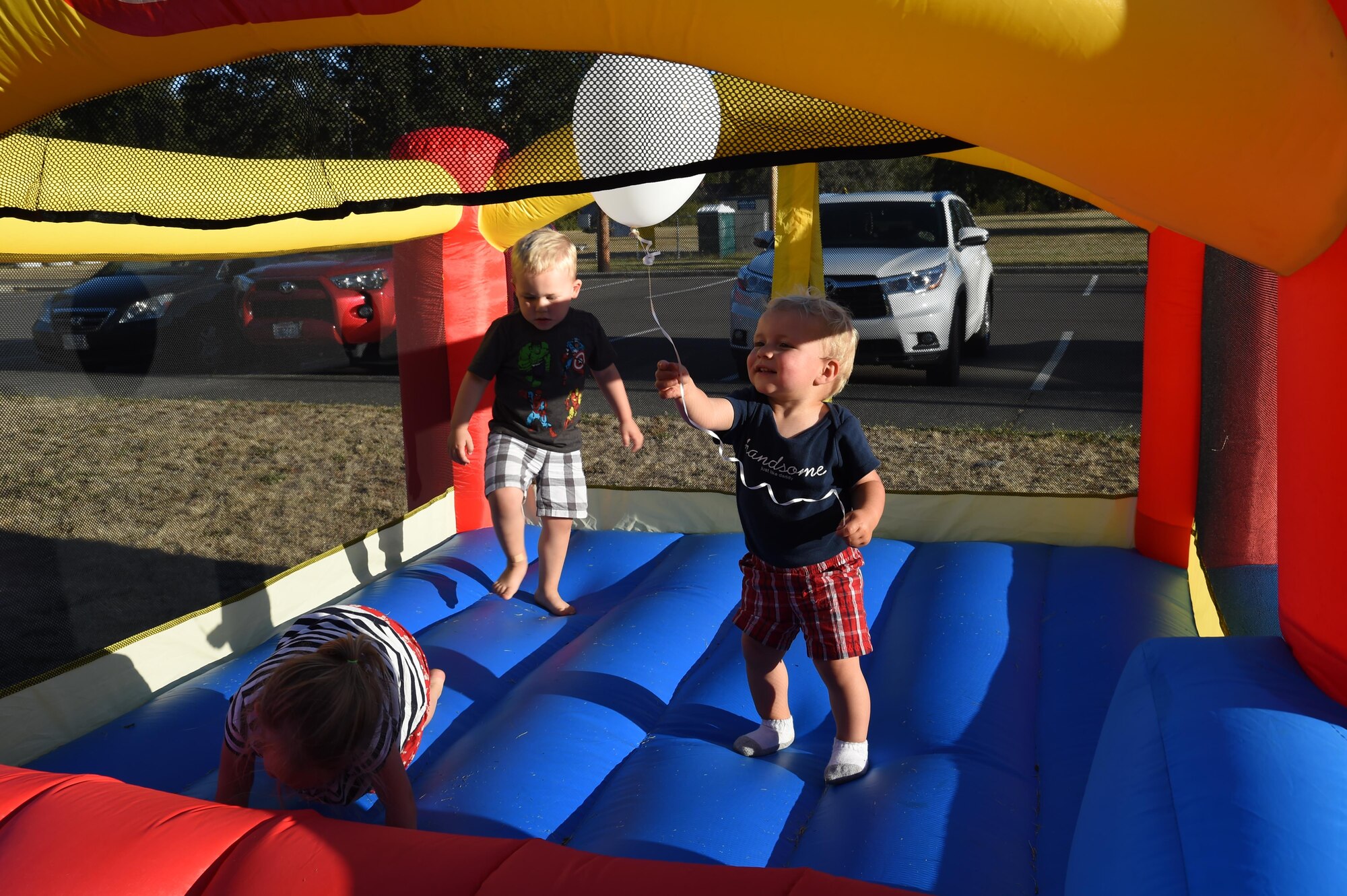 Children of McChord members play in a bouncy castle during the Deployed Family Dinner August 15, 2016, at the Chapel Support Center, Joint Base Lewis-McChord, Wash. More than a dozen kids played in the castles, watched a magician and received a free toy at the event. (U.S. Air Force photo/Staff Sgt. Naomi Shipley)