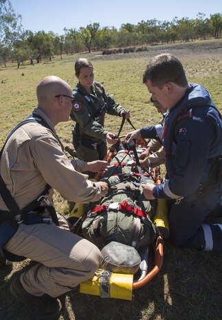 Marine Fighter Attack Squadron (VMFA) 122 U.S. Navy Lt. Matthew Case, flight surgeon, Kurt Pride, rescue crewman with RAAF Tindal Search and Rescue, and Flying Officer Kimberly MacDonald, a nurse with the Royal Australian Air Force, ensure that all buckles and clips are secure during SAR training at Exercise Pitch Black 2016, Royal Australian Air Force Base Tindal, Australia, Aug. 16, 2016. The SAR team trains with local and international forces during exercises like Pitch Black to ensure all medical personnel that can respond to an aircraft emergency are capable of carrying out the same procedures. The biennial, multinational exercise involves approximately 10 allied nations and prepares these forces for possible real-world scenarios. The bilateral effort amongst Exercise Pitch Black 2016 furthermore showcases the strength amongst various militaries and solidifies the relationship across the Pacific region. (U.S. Marine Corps photo by Cpl. Nicole Zurbrugg)
