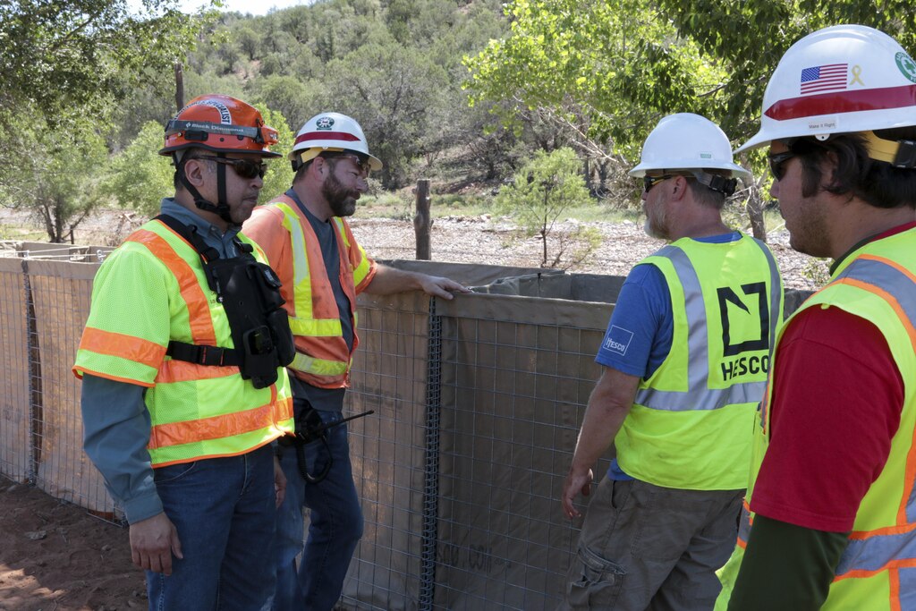 U.S. Army Corps of Engineers Los Angeles District place segmented sections of temporary protective barriers in the community of Cedar Creek, Arizona, Aug. 17. The project is in response to an Aug. 13 request by the White Mountain Apache Tribe to provide assistance to meet an imminent flood threat. Storm flows from the summer monsoon season, in concert with debris flows from the burned watershed upstream, pose a serious threat because limited flood risk minimization measures (K-rails) are currently in place.