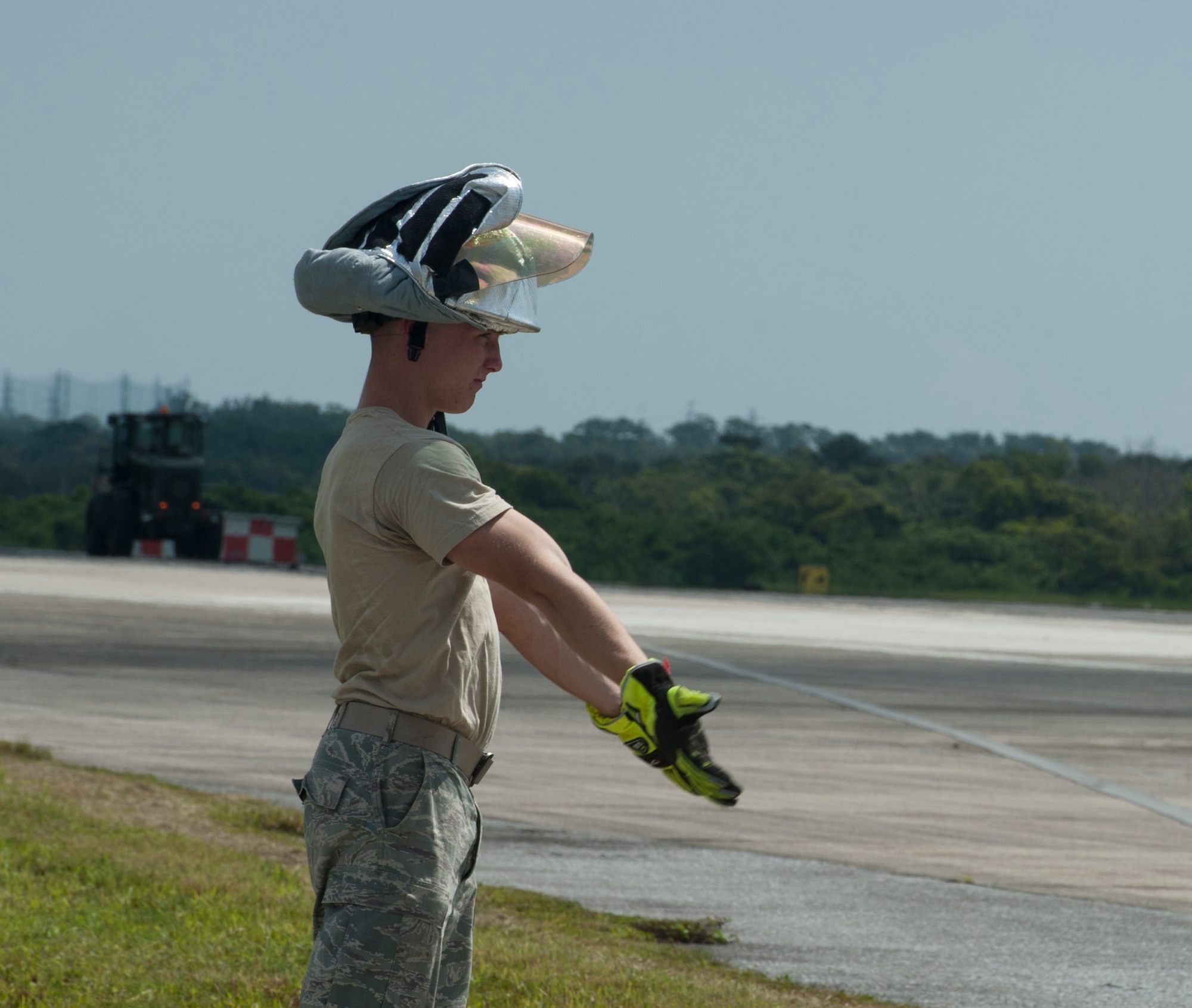 Airman 1st Class Carson Price, 18th Civil Engineer Squadron firefighter, directs personnel in aircraft barrier shacks Aug. 16, 2016, at Kadena Air Base, Japan. After an aircraft landing simulation, the cable of an aircraft barrier needed to be pulled back into the barrier shacks so it could be ready to use for other aircraft. (U.S. Air Force photo by Airman 1st Class Lynette M. Rolen)