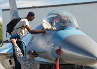 U.S. Air Force Senior Airman Christopher Tidline, a 354th Maintenance Squadron aircrew egress technician, peels a decal from an F-16 Fighting Falcon aircraft while cross-utilizing his time to supplement a crew chief’s position with the 354th Aircraft Maintenance Squadron, Aug. 17, 2016, at Eielson Air Force Base, Alaska. Tidline will work more than 100 hours with the sister squadron who maintains 18th Aggressor Squadron aircraft in support of RED-FLAG-Alaska 16-3, so pilots can share their knowledge of flying with participating units in the exercise. (U.S. Air Force photo by Staff Sgt. Shawn Nickel)
