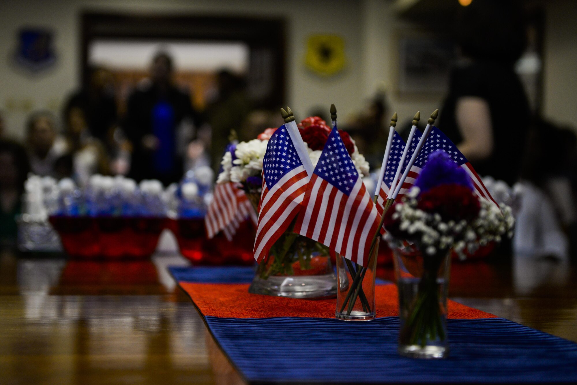 American flags rest as the centerpiece during a naturalization ceremony Aug. 17, 2016, at Kadena Air Base, Japan. Kadena has a strong commitment to helping non-citizen Department of Defense members and their families achieve U.S. citizenship. Since Oct. 1, 2001, U.S. Citizenship and Immigration Services has naturalized 109,321 members of the military, with 11,069 of those service members becoming citizens during USCIS naturalization ceremonies in 34 foreign countries. (U.S. Air Force photo by Senior Airman Stephen G. Eigel)