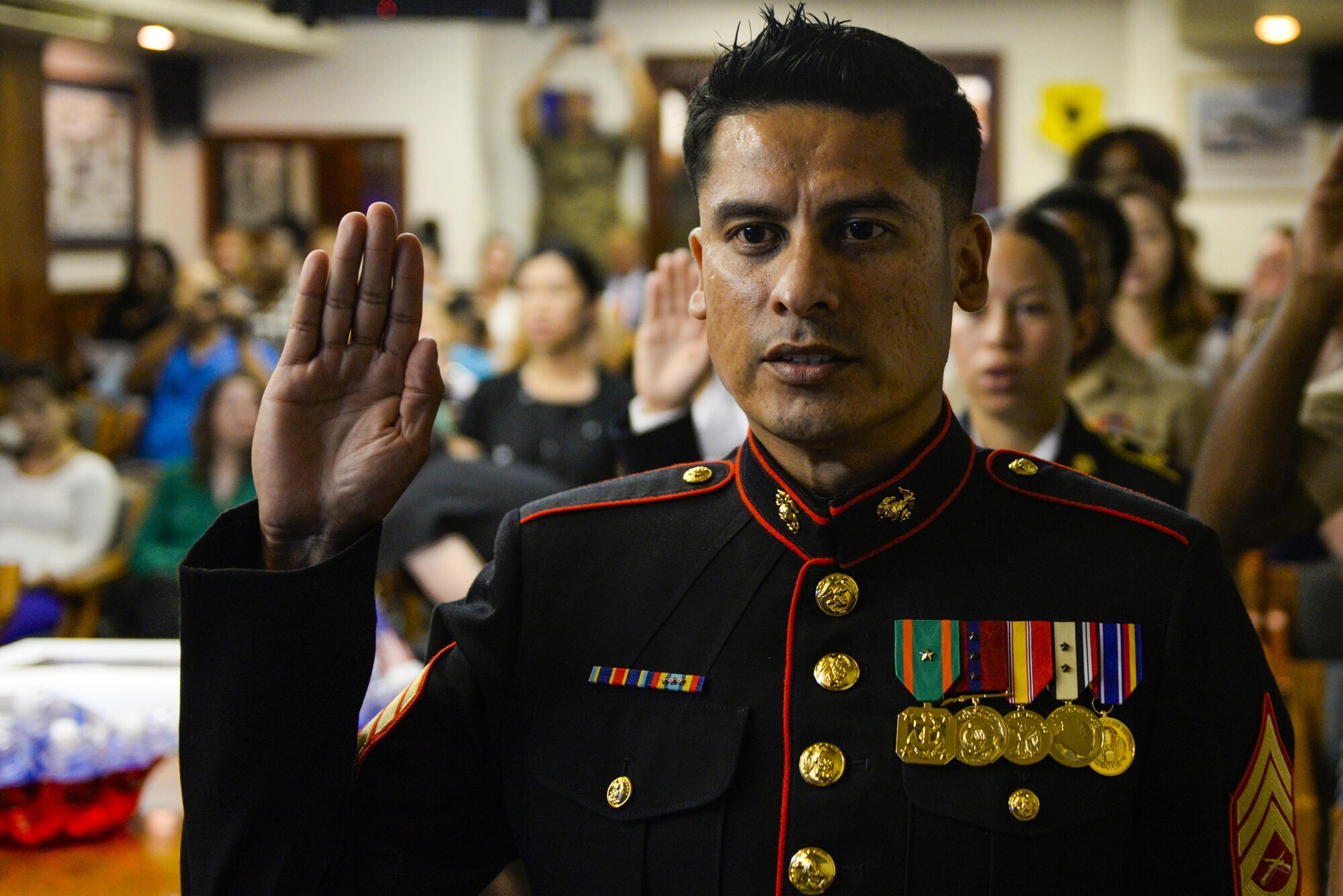 U.S. Marine Corps Staff Sgt. Martin Alonso Balcazar swears the oath of allegiance during a U.S. Naturalization Ceremony Aug. 17, 2016, at Kadena Air Base, Japan. Kadena hosted it's first-ever naturalization ceremony with five military members and 10 dependents earning their citizenship. Since the beginning of fiscal year 2009, U.S. Citizenship and Immigration Services has presented 106 children of members of the military with citizenship certificates during ceremonies in Italy, Germany, Japan, South Korea, and the United Kingdom. (U.S. Air Force photo by Senior Airman Stephen G. Eigel)