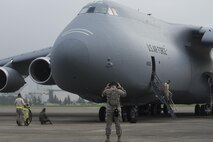 Members with the 621st Contingency Response Squadron conduct preflight checks on a C-5M Super Galaxy at Yokota Air Base, Japan, Aug. 16, 2016. The 621 CRS sent crew chief to Yokota to gain proficiency and training on a range of aircraft, working alongside the 730th Air Mobility Squadron. The 730 AMS often works with C-5, C-17A Globemaster III, KC-135 Stratotanker, KC-10A Extender and civilian aircraft. (U.S. Air Force photo by Yasuo Osakabe/Released)