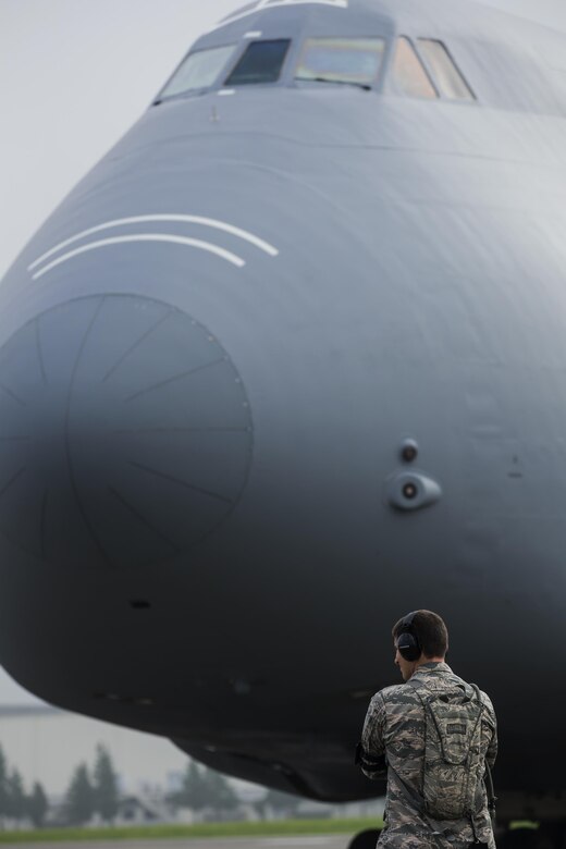 Capt. Aaron Vogeler, 621st Contingency Response Squadron aircraft maintenance flight commander, observes his crew chiefs at Yokota Air Base, Japan, Aug. 16, 2016. The 621 CRS aircraft maintenance personnel are tasked to recover, service and launch multiple types of aircraft used in contingency operations. (U.S. Air Force photo by Yasuo Osakabe/Released)  