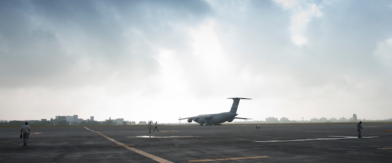 Crew chiefs with the 621st Contingency Response Squadron search for foreign objected debris at Yokota Air Base, Japan, Aug. 16, 2016. The 621 CRS Airmen visited Yokota to work alongside the 730th Air Mobility Squadron, gaining experience on a variety of air frames, including C-5s, C-17 Globemaster IIIs, and civilian aircraft. (U.S. Air Force photo by Yasuo Osakabe/Released)