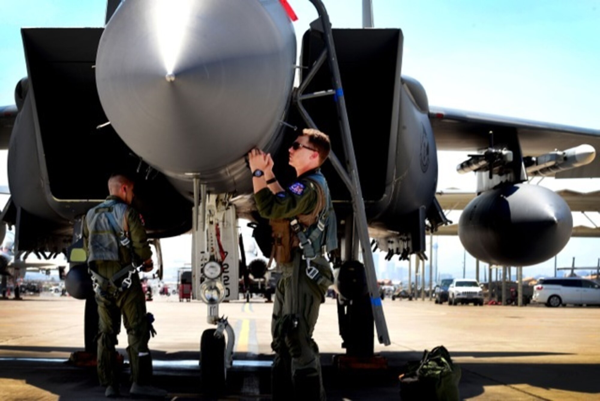 U.S. Air Force 1st Lieutenant Drew Lyons, 492nd Fighter Squadron, F-15E Strike Eagle pilot, and 1st Lieutenant J. Paul Reasner, 492nd FS, F-15E Strike Eagle weapon systems officer inspect their aircraft prior to a sortie in support of exercise Red Flag 16-4 at Nellis Air Force Base, Nev. Aug 17. Red Flag is a realistic combat exercise involving U.S. and allied air forces conducing training operations on the 15,000 square mile Nevada Test and Training Range. (U.S. Air Force photo/ Tech. Sgt. Matthew Plew)