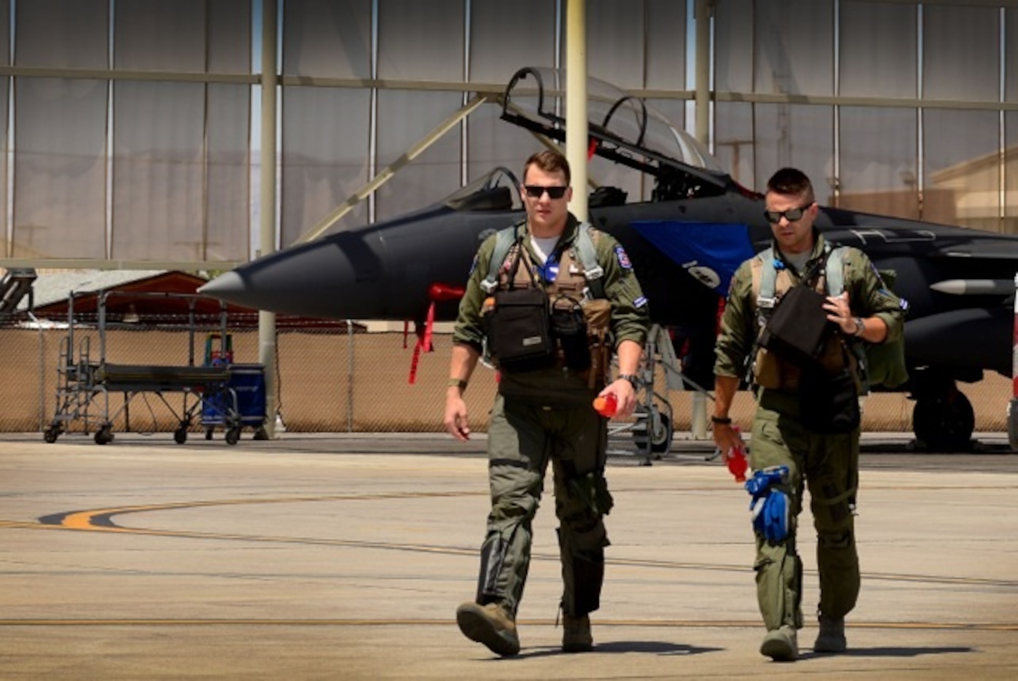 U.S. Air Force 1st Lieutenant Drew Lyons, 492nd Fighter Squadron, F-15E Strike Eagle pilot, and 1st Lieutenant J. Paul Reasner, 492nd FS, F-15E Strike Eagle weapon systems officer, step to their aircraft for a sortie in support of exercise Red Flag 16-4 at Nellis Air Force Base, Nev. Aug 17. Red Flag is the U.S. Air Force’s premier air-to-air combat training exercise and one of a series of advanced training programs that is administered by the U.S. Air Force Warfare Center and executed through the 414th Combat Training Squadron. (U.S. Air Force photo/ Tech. Sgt. Matthew Plew)