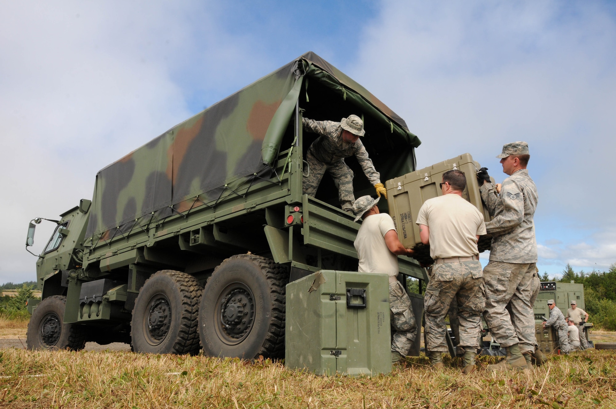 Oregon Air National Guard members, 270th Air Traffic Control Squadron, load a M1083 five-ton cargo truck during the ATCS annual training at Newport, Ore., Aug. 10, 2016. Members convoyed nearly 300 miles from Klamath Falls, Ore., where they set up their MSN-7 mobile tower, TRN-48 Tactical Air Navigation (TACAN) system, and all supporting equipment which allows them to guide aircraft into and out of nearly any airfield in the world. (U.S. Air National Guard photo by Staff Sgt. Penny Snoozy)