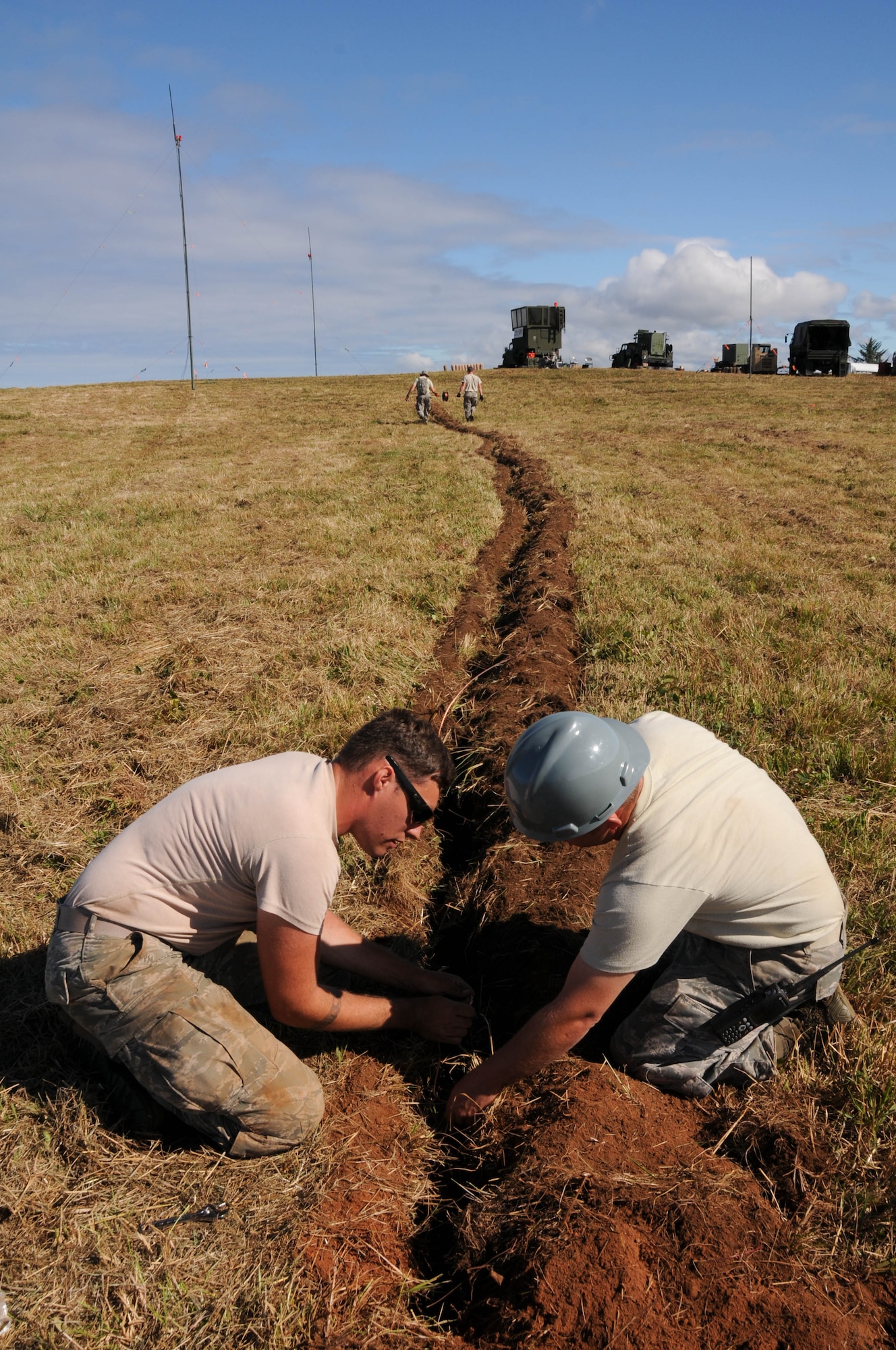 Oregon Air National Guard members, 270th Air Traffic Control Squadron, lay down copper wire for the grounding system during the ATCS annual training at Newport, Ore., Aug. 10, 2016. Members convoyed nearly 300 miles from Klamath Falls, Ore., where they set up their MSN-7 mobile tower, TRN-48 Tactical Air Navigation (TACAN) system, and all supporting equipment which allows them to guide aircraft into and out of nearly any airfield in the world. (U.S. Air National Guard photo by Staff Sgt. Penny Snoozy)