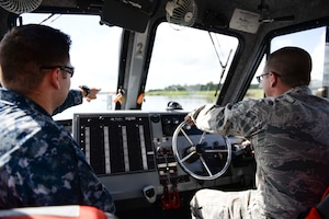 Senior Airman Austin Walworth conducts training with Master at Arms 1st Class Jeremy Krieg and Master at Arms 1st Class Brian Cobb on a Harbor Patrol Unit boat embedded in the 628th Security Forces Squadron at Joint Base Charleston. Walworth recently earned the Navy Small Craft Insignia, the first Airman ever to do so. (U.S. Navy Photo by Mass Communication Specialist 2nd Class John Haynes/Released)