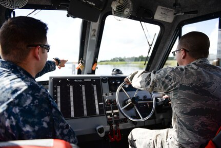 Senior Airman Austin Walworth conducts training with Master at Arms 1st Class Jeremy Krieg and Master at Arms 1st Class Brian Cobb on a Harbor Patrol Unit boat embedded in the 628th Security Forces Squadron at Joint Base Charleston. Walworth recently earned the Navy Small Craft Insignia, the first Airman ever to do so. (U.S. Navy Photo by Mass Communication Specialist 2nd Class John Haynes/Released)