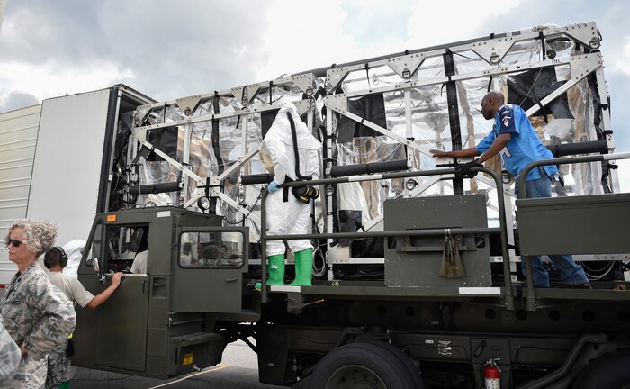 A Transportation Isolation System (TIS) is loaded into the TIS Hot Air Decontamination System (THADS) at Joint Base Charleston during Exercise Mobility Solace, Aug. 17, 2016. Mobility Solace provides Air Mobility Command, working with joint partners, the opportunity to evaluate the protocols and operational sequences of moving multiple patients exposed or infected with Ebola using the TIS, while also minimizing the risks to aircrew, medical attendants and the airframe. The TIS is a modular, scalable system, composed of at least one isolation pallet for patient transportation and care, one pallet configured as an antechamber to provide medical members with an enclosed space to safely decontaminate and remove their personal protective equipment before exiting. (U.S. Air Force Photo/Airman Megan Munoz)