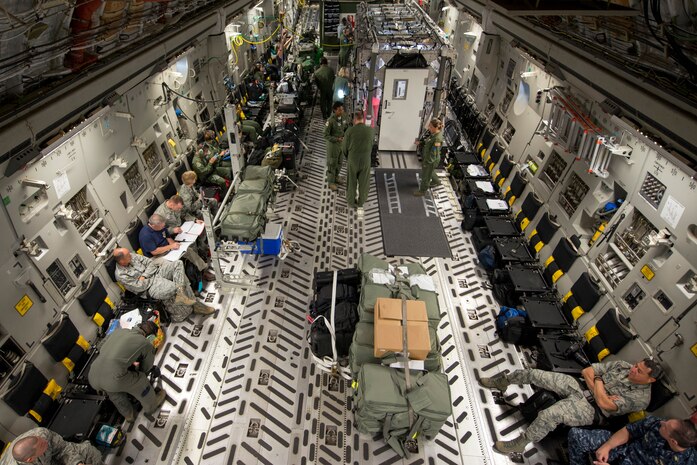 Air Mobility Airmen fly to Joint Base Andrews, Md. during Exercise Mobility Solace, August 16, 2016. Mobility Solace provides Air Mobility Command, working with joint partners, the opportunity to evaluate the protocols and operational sequences of moving multiple patients exposed or infected with Ebola using the TIS, while also minimizing the risks to aircrew, medical attendants and the airframe. The TIS is a modular, scalable system, composed of at least one isolation pallet for patient transportation and care, one pallet configured as an antechamber to provide medical members with an enclosed space to safely decontaminate and remove their personal protective equipment before exiting. (U.S. Air Force Photo/Airman Megan Munoz)