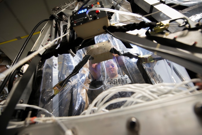 Staff Sgt. Aaron De L'Etoile, the 628th Medical Group Bioenviornmental Engineering NCO in charge, adjusts the preasure settings of a Transportation Isolation System (TIS) during Exercise Mobility Solace at Joint Base Charleston, S.C., Aug. 15, 2016. Mobility Solace provides Air Mobility Command, working with joint partners, the opportunity to evaluate the protocols and operational sequences of moving multiple patients exposed or infected with Ebola using the TIS, while also minimizing the risks to aircrew, medical attendants and the airframe. The TIS is a modular, scalable system, composed of at least one isolation pallet for patient transportation and care, one pallet configured as an antechamber to provide medical members with an enclosed space to safely decontaminate and remove their personal protective equipment before exiting. (U.S. Air Force Photo/Airman Megan Munoz)