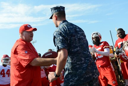 Andy Reid, Kansas City Chiefs head coach, presents a game ball to U.S. Navy Petty Officer 1st Class Matthew Young, executive officer to U.S. Strategic Command's (USSTRATCOM) senior enlisted leader, after the final practice of the team's training camp in St. Joseph, Mo., Aug. 18, 2016. While there, service members assigned to Offutt Air Force Base, Neb.; Fort Riley, Kan.; Fort Leavenworth, Kan.; Whiteman AFB, Mo.; and Rosecrans Reserve Air National Guard Base, Mo.; observed the Chiefsâ€™ practice session, and were invited onto the field to meet with players and coaches. Young was one of several joint and international military members to receive a game ball from Reid after the practice session. One of nine DoD unified combatant commands, USSTRATCOM has global strategic missions assigned through the Unified Command Plan, which include strategic deterrence; space operations; cyberspace operations; joint electronic warfare; global strike; missile defense; intelligence, surveillance and reconnaissance; combating weapons of mass destruction; and analysis and targeting. (U.S. Air Force photo by Staff Sgt. Jonathan Lovelady)