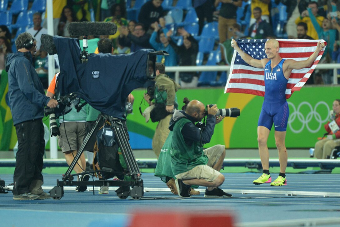 Army Reserve 2nd Lt. Sam Kendricks of Oxford, Miss., poses for photographers after winning the bronze medal in the men's pole vault at the 2016 Olympic Games in Rio de Janeiro, Aug. 15, 2016. Army photo by Tim Hipps