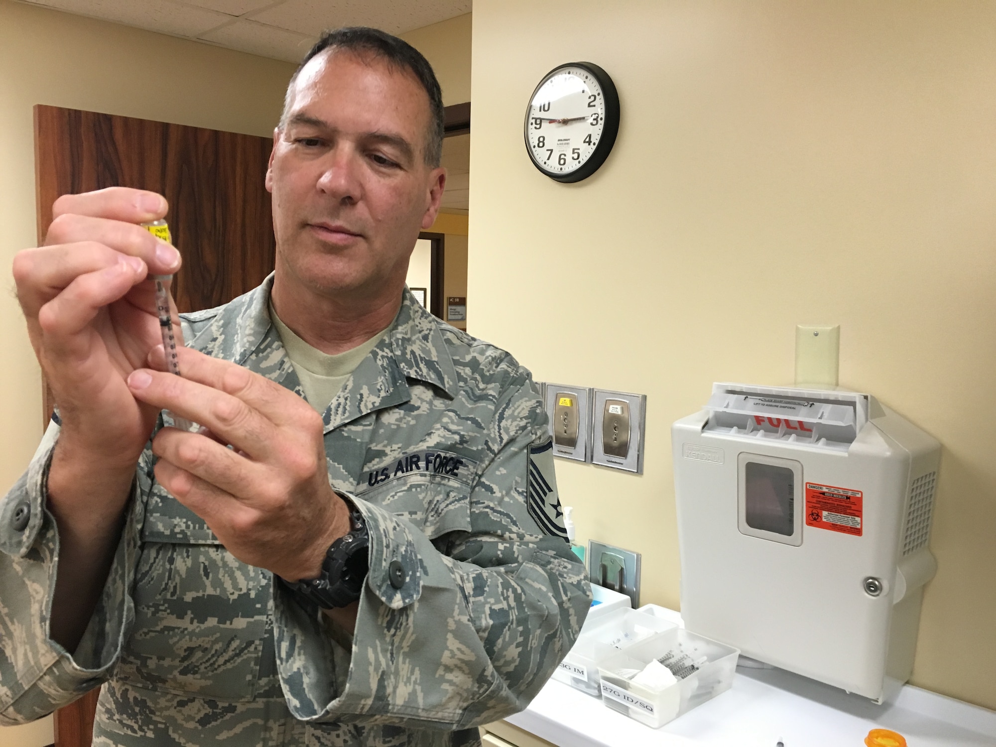 Master Sgt. Kevin Roper, medical technician with the 419th Medical Squadron, administers vaccinations at the Tripler Army Medical Center in Honolulu, Hawaii. Roper spent time preparing patients for procedures and assisting with administration while working at TAMC during his two-week annual training, honing his techniques and completing required medical skills refresher training. Roper also worked in the gastroenterology section where he worked with up to 11 patients a day. (U.S. Air Force photo/Staff Sgt. Christina Judd)