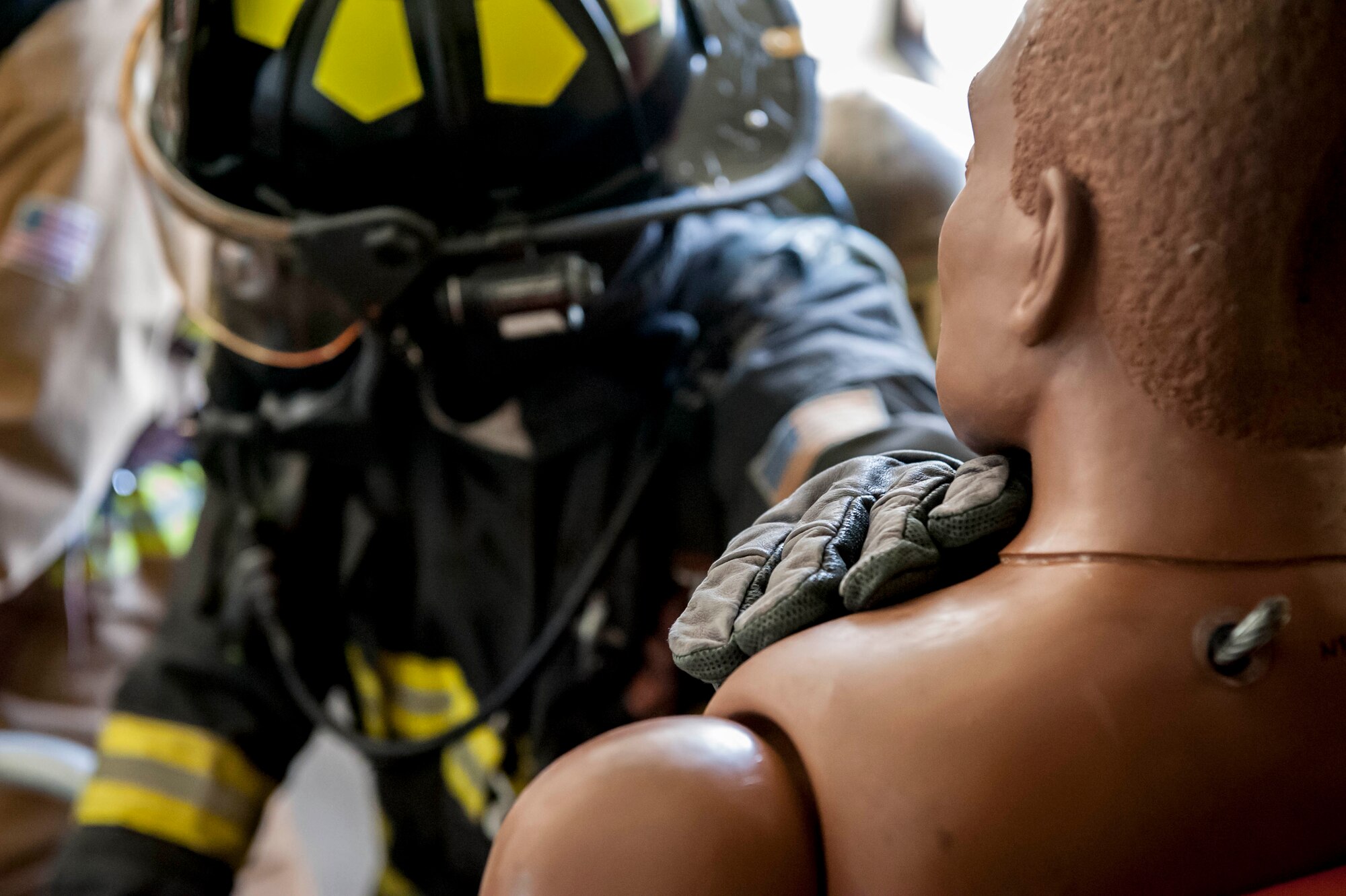 Staff Sgt. Demarcus Oliver, 18th Civil Engineer Squadron firefighter crew chief, supports a dummy during a tower evacuation drill Aug. 15, 2016, at Kadena Air Base, Japan. Training up to twice per week, firefighters ensure they remain constantly ready for possible emergencies, such as building evacuations and personnel recovery. (U.S. Air Force photo by Senior Airman Peter Reft)