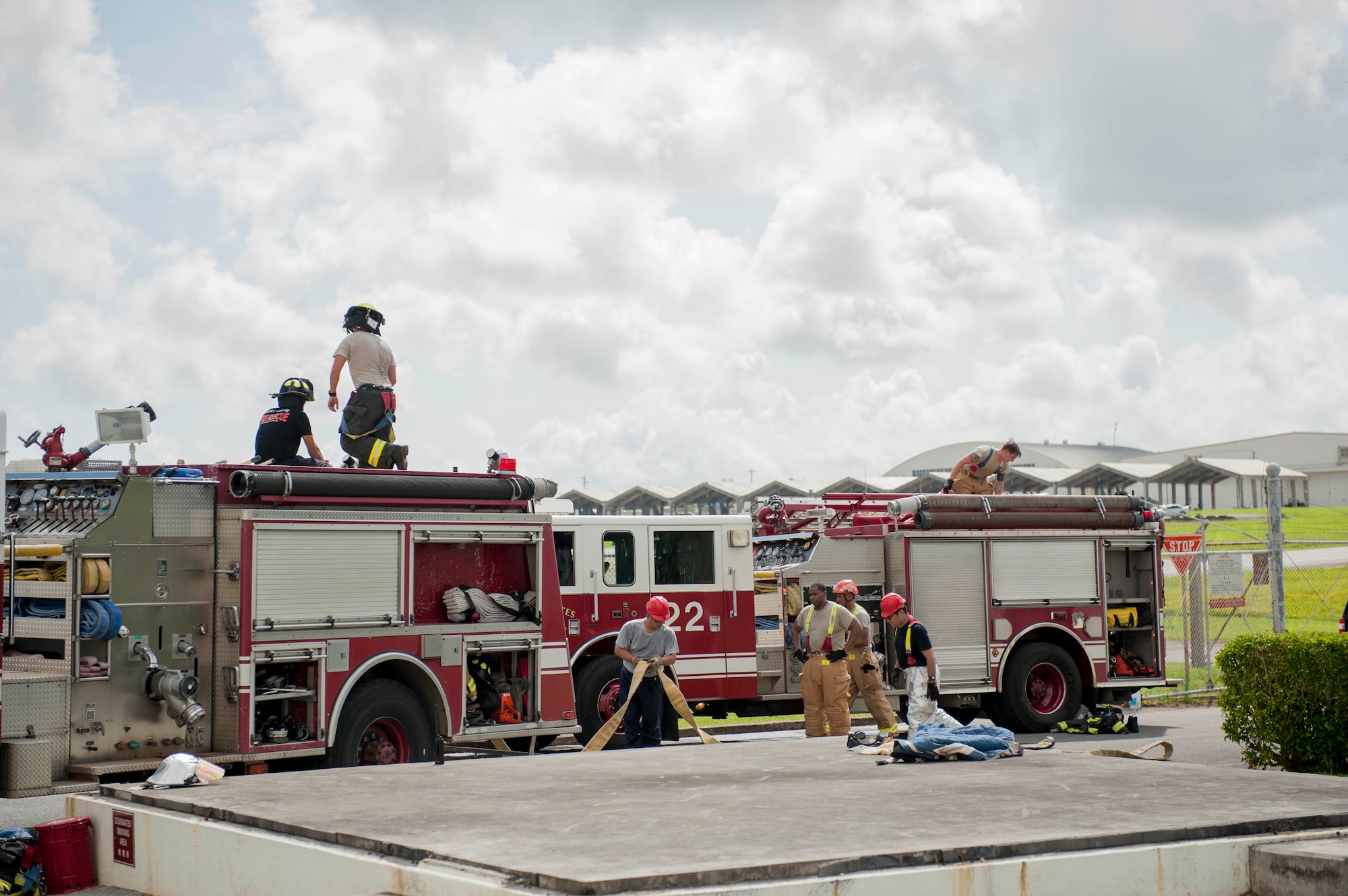 Firefighters of the 18th Civil Engineer Squadron secure fire hoses during a tower evacuation drill Aug. 15, 2016, at Kadena Air Base, Japan. Firefighters trained in the tower to become familiar with the facility in the event there is a need for a real-world emergency evacuation. (U.S. Air Force photo by Senior Airman Peter Reft)