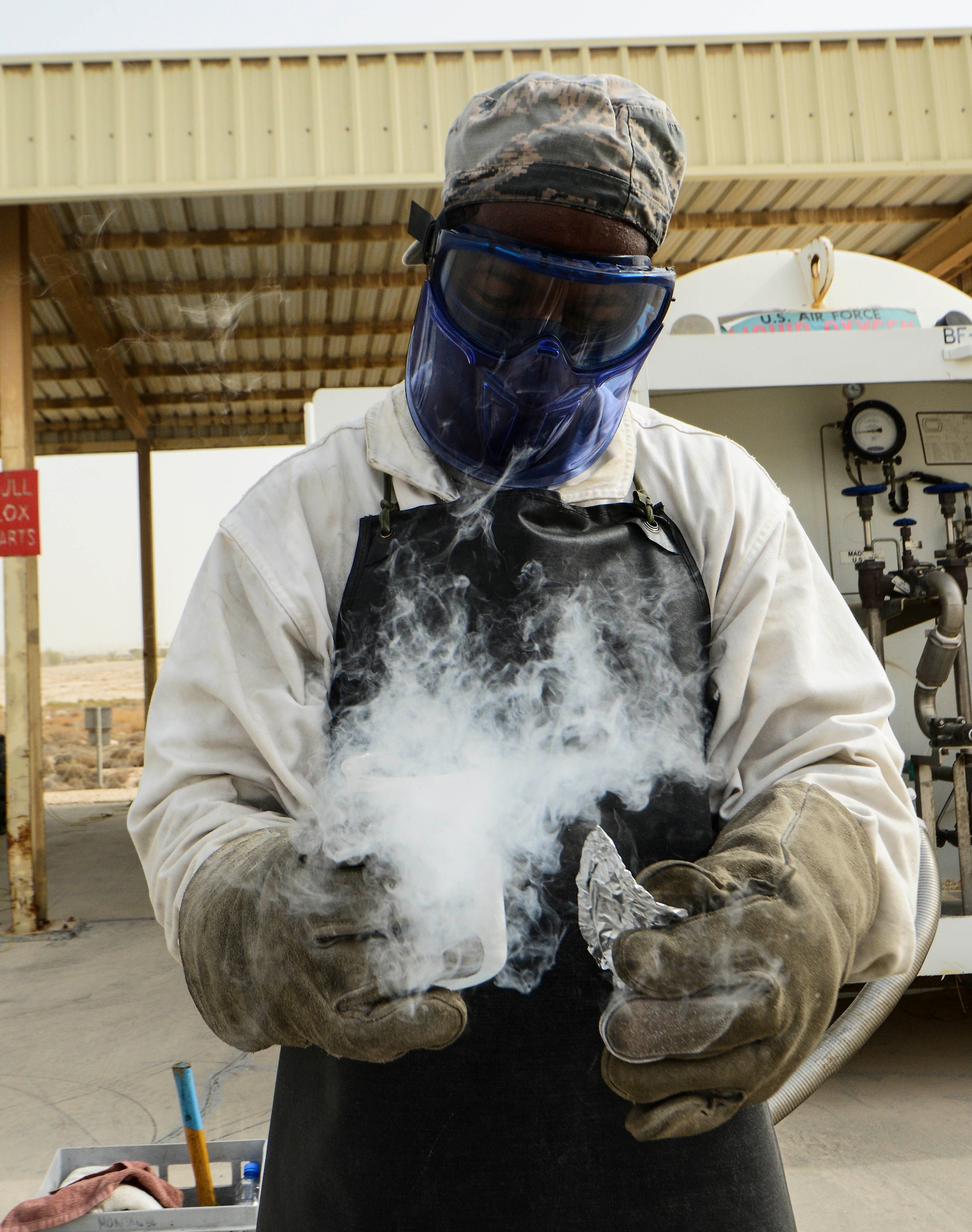 Senior Airman Donte Hatcher, 379th Expeditionary Logistics Readiness Squadron fuels cryogenic operator, takes an odor sample of the liquid oxygen tank to ensure its safety during an inspection Aug. 5, 2016, at Al Udeid Air Base, Qatar. The cryogenics team has the capability to ship their products to multiple locations in the U.S. Air Forces Central Command area of responsibility. (U.S. Air Force photo/Senior Airman Janelle Patiño/Released)