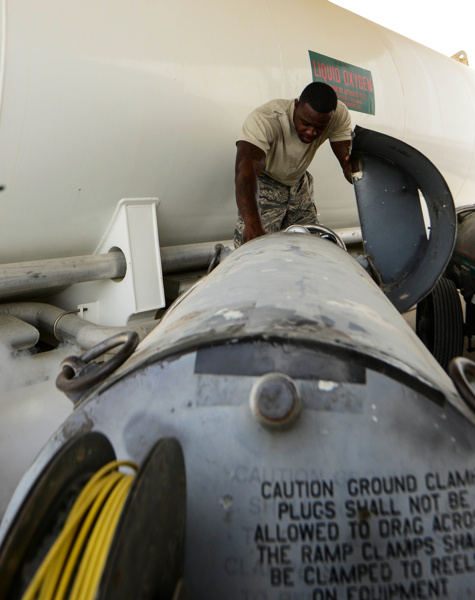 Tech. Sgt. Alexander Sasser, 379th Expeditionary Logistics Readiness Squadron fuels cryogenics NCO in charge, levels out the gauge to ensure the right amount of pressure is in a 50-gallon liquid oxygen tank during an inspection Aug. 5, 2016, at Al Udeid Air Base, Qatar. The cryogenics team here produces liquid oxygen, which is primarily used as aviator breathing oxygen, and liquid nitrogen, which is used for tire pressure and medical purposes. (U.S. Air Force photo/Senior Airman Janelle Patiño/Released)