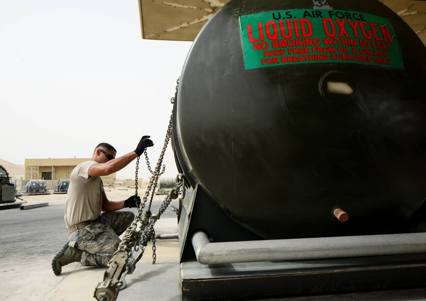 Staff Sgt. John Saninoncio, 379th Expeditionary Logistics Readiness Squadron fuels cryogenics supervisor, replaces the tie downs of a 400-gallon liquid oxygen tank to secure the tank onto a pallet prior to an aircraft shipment Aug. 5, 2016, al Al Udeid Air Base, Qatar. The cryogenics team supplies, receives and issues liquid oxygen and liquid nitrogen tanks to 11 bases within the U.S. Air Forces Central Command’s area of responsibility. (U.S. Air Force photo/Senior Airman Janelle Patiño/Released)