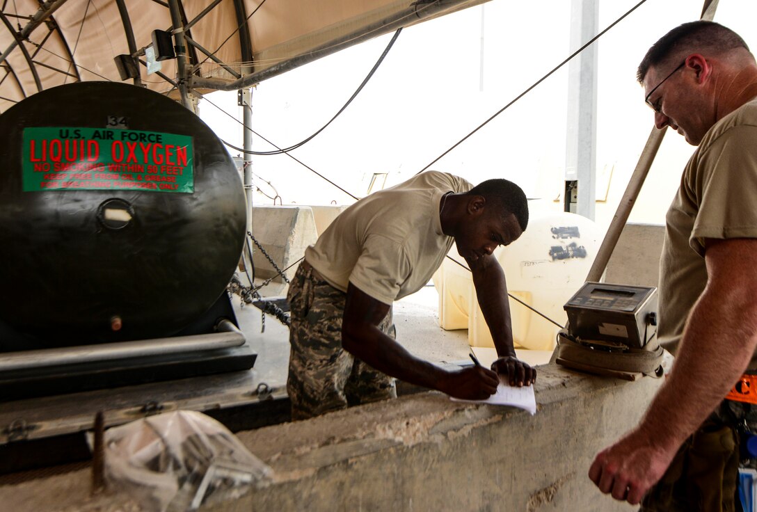 Tech. Sgt. Alexander Sasser, 379th Expeditionary Logistics Readiness Squadron fuels cryogenics NCO in charge, signs paperwork after weighing a 400-gallon liquid oxygen tank in preparation of an aircraft shipment Aug. 5, 2016, at Al Udeid Air Base, Qatar. The 379th ELRS maintains three large storage tanks that contain liquid oxygen and liquid nitrogen along with 51 liquid oxygen and liquid nitrogen carts that ship daily to other bases throughout the U.S. Air Forces Central Command’s area of responsibility. (U.S. Air Force photo/Senior Airman Janelle Patiño/Released)