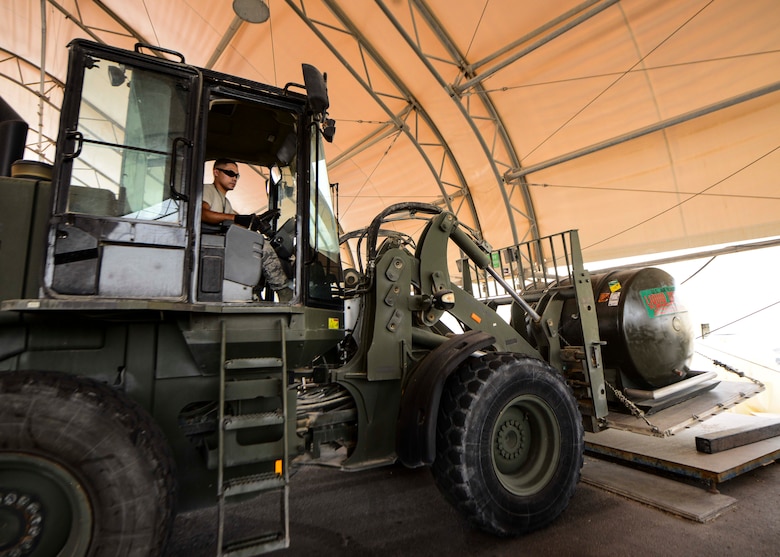 Staff Sgt. John Saninoncio, 379th Expeditionary Logistics Readiness Squadron fuels cryogenics supervisor, places a 400-gallon liquid oxygen tank on a weighing scale using a forklift in preparation of an aircraft shipment Aug. 5, 2016, at Al Udeid Air Base, Qatar. The 379th ELRS maintains three large storage tanks that contain liquid oxygen and liquid nitrogen along with 51 liquid oxygen and liquid nitrogen carts that ship daily to other bases throughout the U.S. Air Forces Central Command’s area of responsibility. (U.S. Air Force photo/Senior Airman Janelle Patiño/Released)
