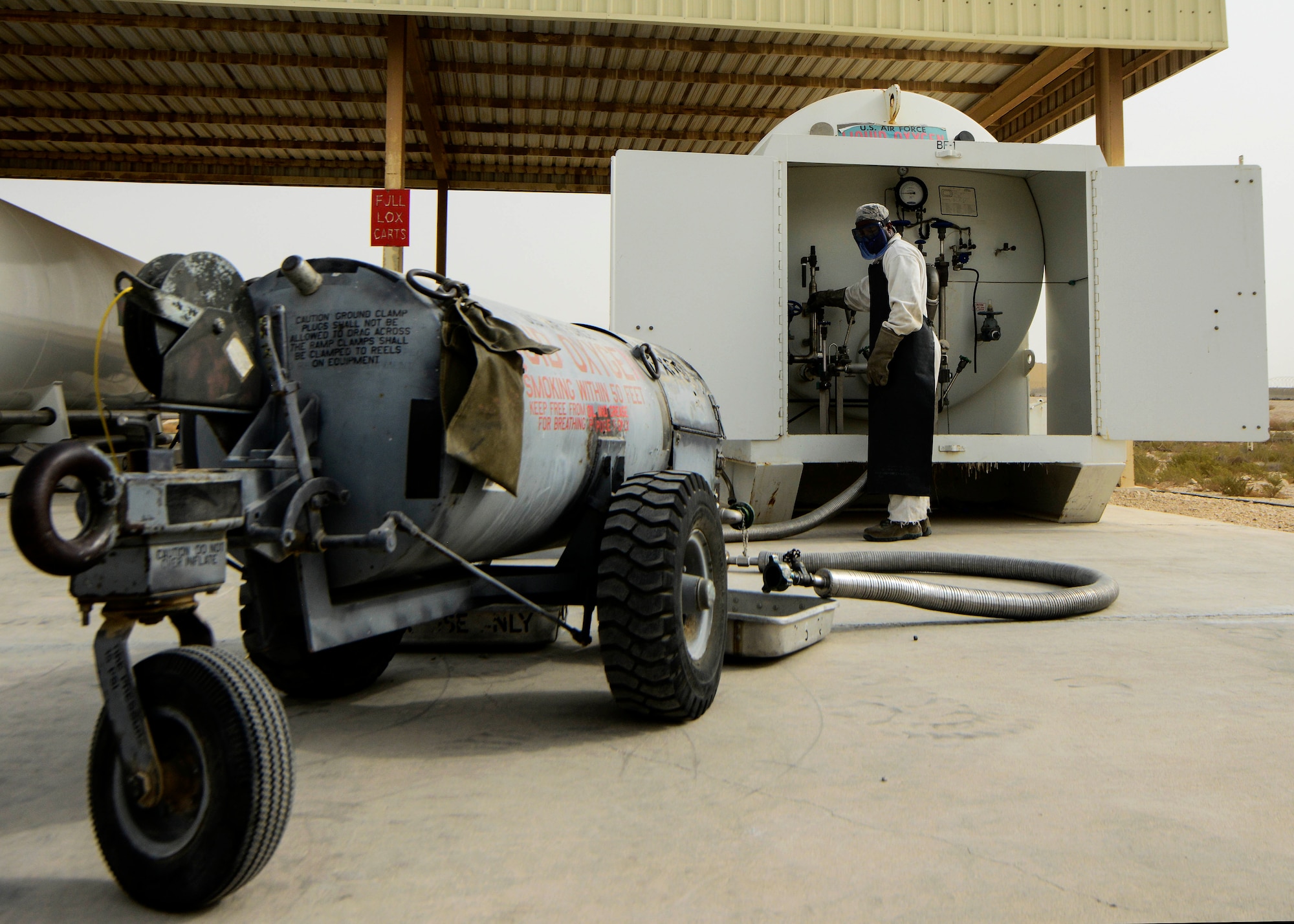 Senior Airman Donte Hatcher, 379th Expeditionary Logistics Readiness Squadron fuels cryogenics operator, fills a 50-gallon liquid oxygen tank during an inspection Aug. 5, 2016, at Al Udeid Air Base, Qatar.  Liquid nitrogen and oxygen tanks are recharged into aircraft to provide aircrews with pure oxygen at altitude during missions conducted in support of Operation Inherent Resolve. (U.S. Air Force photo/Senior Airman Janelle Patiño/Released)