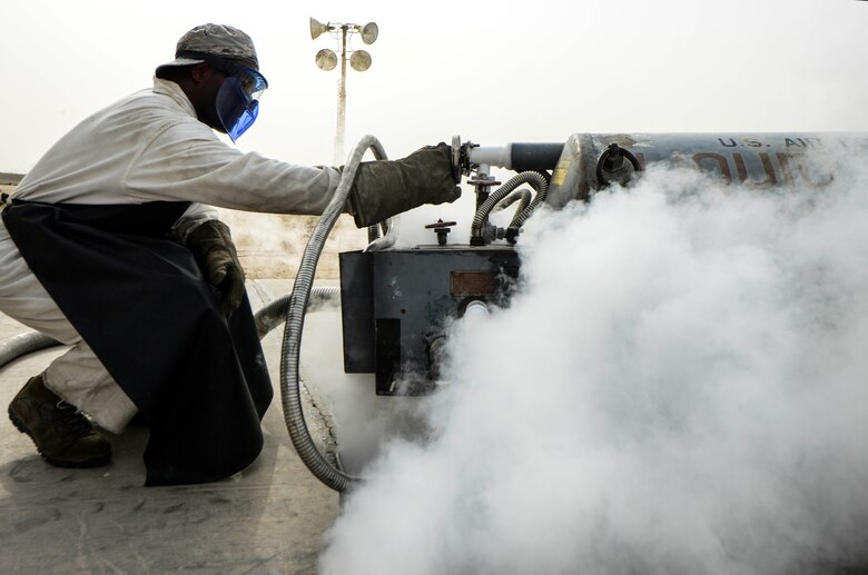 Senior Airman Donte Hatcher, 379th Expeditionary Logistics Readiness Squadron fuels cryogenic operator, levels out the gauge to see the amount of pressure a 50-gallon liquid oxygen tank has during an inspection Aug. 5, 2016, at Al Udeid Air Base, Qatar. The cryogenics team fills tanks full of liquid oxygen and liquid nitrogen to transport onto the flight line to ensure the aircrew has pure oxygen to conduct the mission. (U.S. Air Force photo/Senior Airman Janelle Patiño/Released)