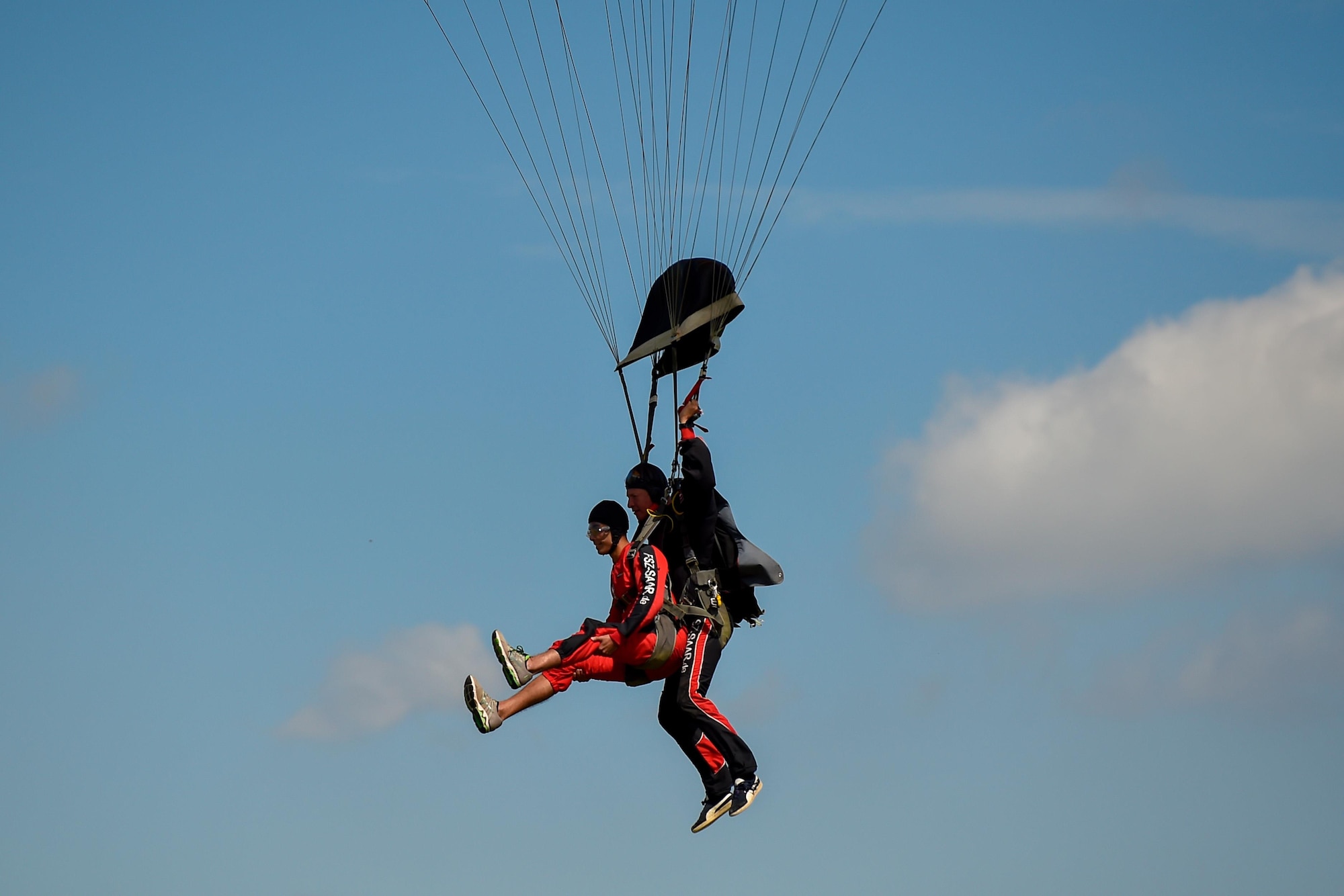 Airman 1st Class Demitrius Como, 24th Intelligence Squadron geospatial analyst, prepares for a landing after a tandem-skydiving jump over Wallerfangen, Germany, Aug. 13, 2016. The purpose of the trip was to improve the spiritual fitness of the Airmen by allowing them to take a leap of faith. (U.S. Air Force photo/Senior Airman Nicole Keim)