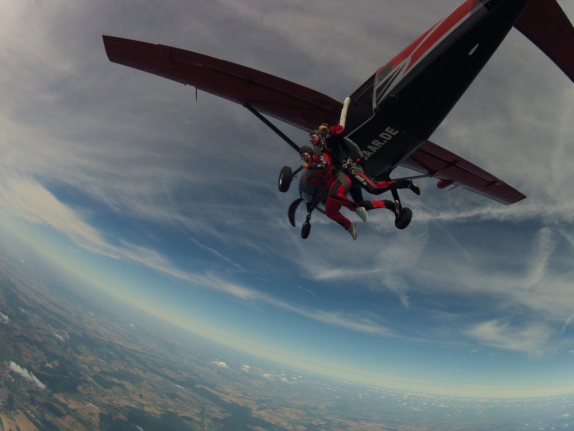 Senior Airman Nicole Keim, 86th Airlift Wing Public Affairs photojournalist, and a skydiver jump out of an airplane over Wallerfangen, Germany, Aug. 13, 2016. The purpose of the trip was to improve the spiritual fitness of the Airmen by allowing them to take a leap of faith. (Courtesy photo) 