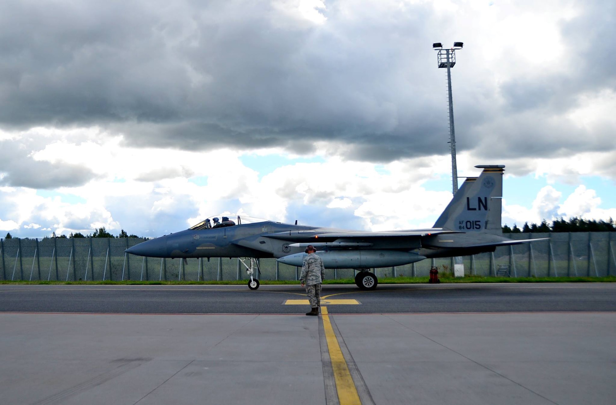 A U.S. Air Force crew chief assigned to the 748th Aircraft Maintenance Squadron from Royal Air Force Lakenheath, England, directs a 493rd Fighter Squadron F-15C Eagle at Ämari Air Base, Estonia, Aug. 12, 2016. The Airmen and aircraft are participating in a multinational exercise including the U.S., Sweden, Finland, the U.K., and Estonia, and highlights the allies’ mutual abilities to work together toward regional security. (U.S. Air  Force photo/Senior Airman Erin Trower)