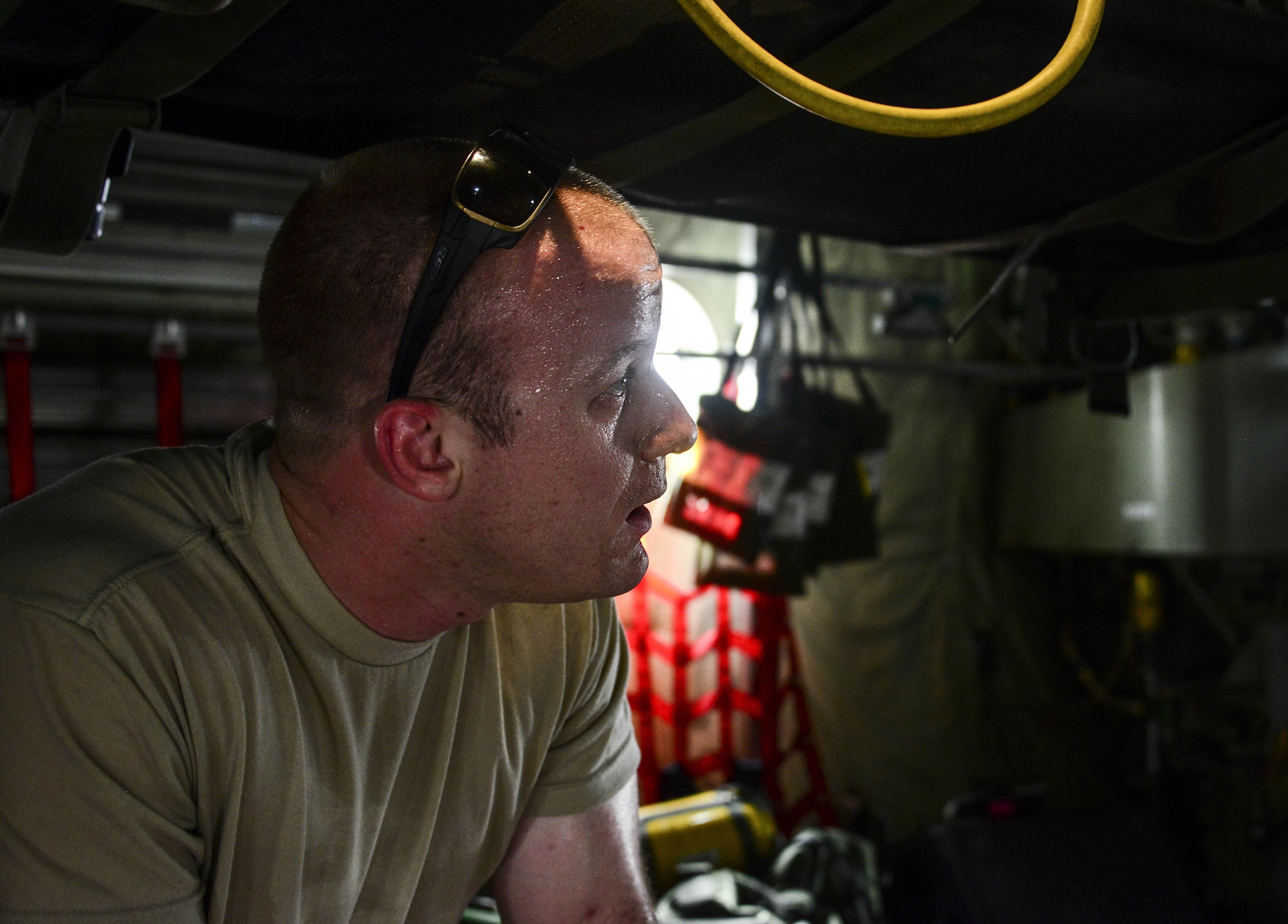 Staff Sgt. Andrew Harkcom, 379th Expeditionary Aeromedical Evacuation Squadron aeromedical evacuation technician, talks with team members while setting up a C-130 Hercules prior to cargo and passengers arriving July 28, 2016, at Al Udeid Air Base, Qatar. The equipment package for an aeromedical evacuation mission contains roughly about 1,200 to 1,400 pounds of equipment on each mission. (U.S. Air Force photo/Senior Airman Janelle Patiño/Released)