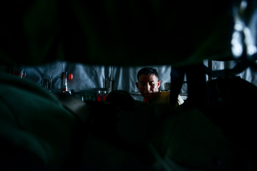 Maj. Bernard Huhane, 379th Expeditionary Aeromedical Evacuation Squadron medical crew director, completes function checks on emergency equipment prior to take off July 28, 2016, at Al Udeid Air Base, Qatar. The aeromedical evacuation team works with aeromedical evacuation operations team to configure the aircraft prior to every mission by setting up the stations and dropping the straps for incoming patients and equipment to be stored during the flight. (U.S. Air Force photo/Senior Airman Janelle Patiño/Released)