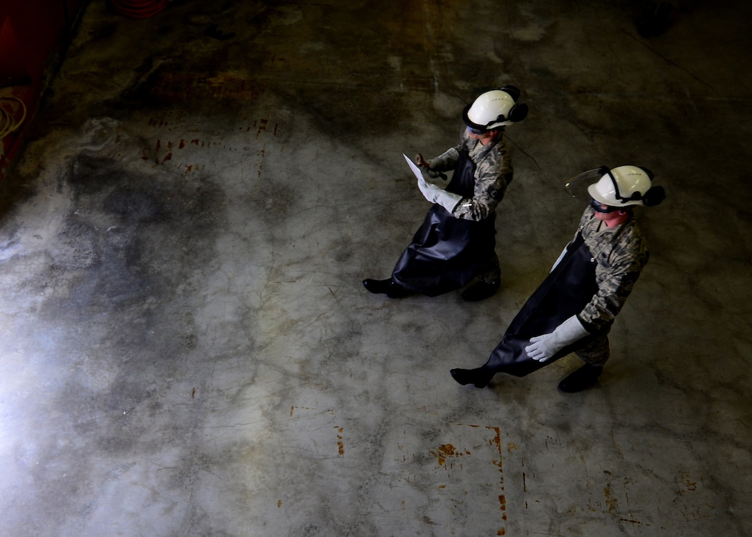 (From left) Staff Sgt. Chantz Wyant and Airman 1st Class Aaron Debolt, 31st Logistics Readiness Squadron fuels facility personnel, walk to a cryogenic tank, Aug. 10, 2016, at Aviano Air Base, Italy. Cryogenics Airmen must wear special equipment to protect themselves from the liquid oxygen and nitrogen’s dangerously low temperatures of minus 297 and minus 320 degrees Fahrenheit respectively. (U.S. Air Force photo by Senior Airman Areca T. Bell/Released)