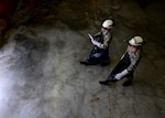 (From left) Staff Sgt. Chantz Wyant and Airman 1st Class Aaron Debolt, 31st Logistics Readiness Squadron fuels facility personnel, walk to a cryogenic tank, Aug. 10, 2016, at Aviano Air Base, Italy. Cryogenics Airmen must wear special equipment to protect themselves from the liquid oxygen and nitrogen’s dangerously low temperatures of minus 297 and minus 320 degrees Fahrenheit respectively. (U.S. Air Force photo by Senior Airman Areca T. Bell/Released)