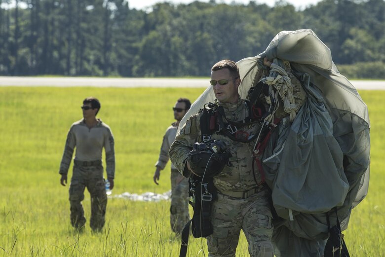 U.S. Air Force Senior Master Sgt. Kenneth Marshall, 38th Rescue Squadron pararescueman, carries his parachute after landing from a high-altitude, low-opening jump, Aug. 18, 2016, at Moody Air Force Base, Ga. The jump was conducted to re-familiarize aircrew and pararescue members with procedures for dropping from a high altitude and to ensure proficiency. (U.S. Air Force photo by Airman 1st Class Daniel Snider)
